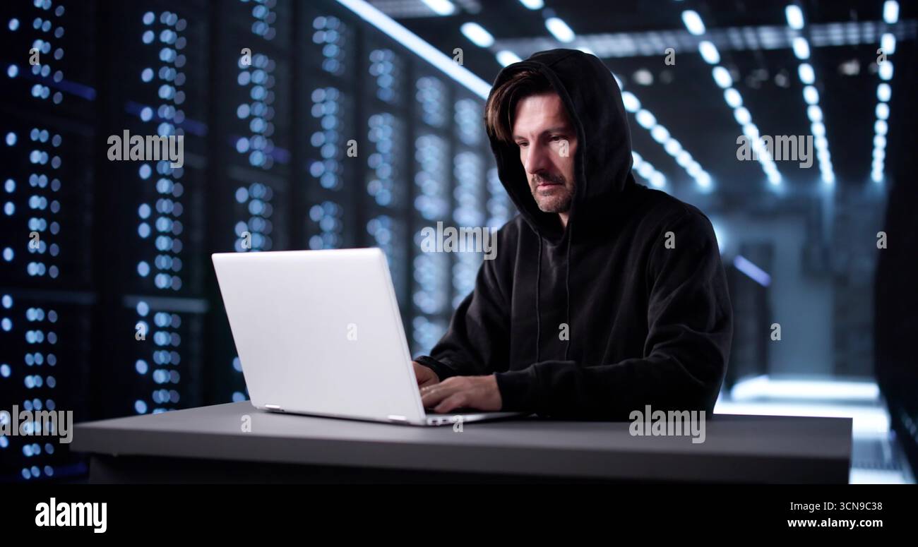 Man In Mask Breaks Into Virtual System, Hacking For Data. Stock Photo
