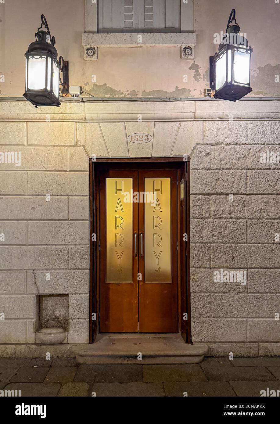 Entrance door of the Harry's Bar, historic bar-restaurant founded in 1931 by Giuseppe Cipriani and declared national heritage, Venice, Veneto, Italy - Smartphone Captured Stock Image