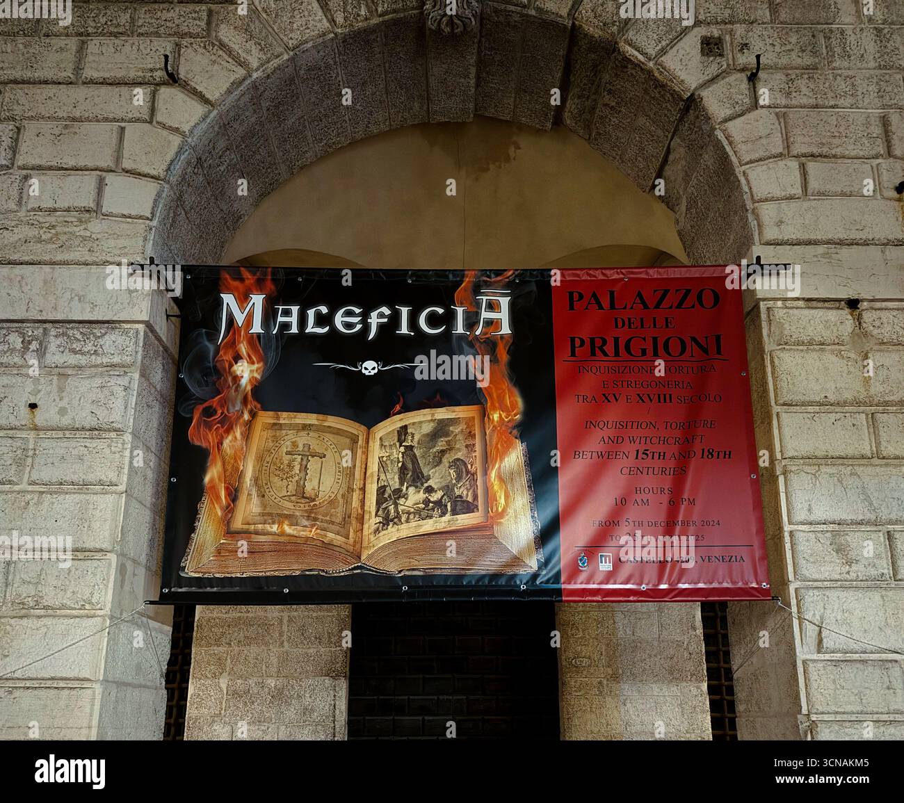 Billboard of 'Maleficia', an exhibition on Inquisition and witchcraft, on the facade of Palazzo delle Prigioni (Prisons Palace), Venice, Italy - Smartphone Captured Stock Image