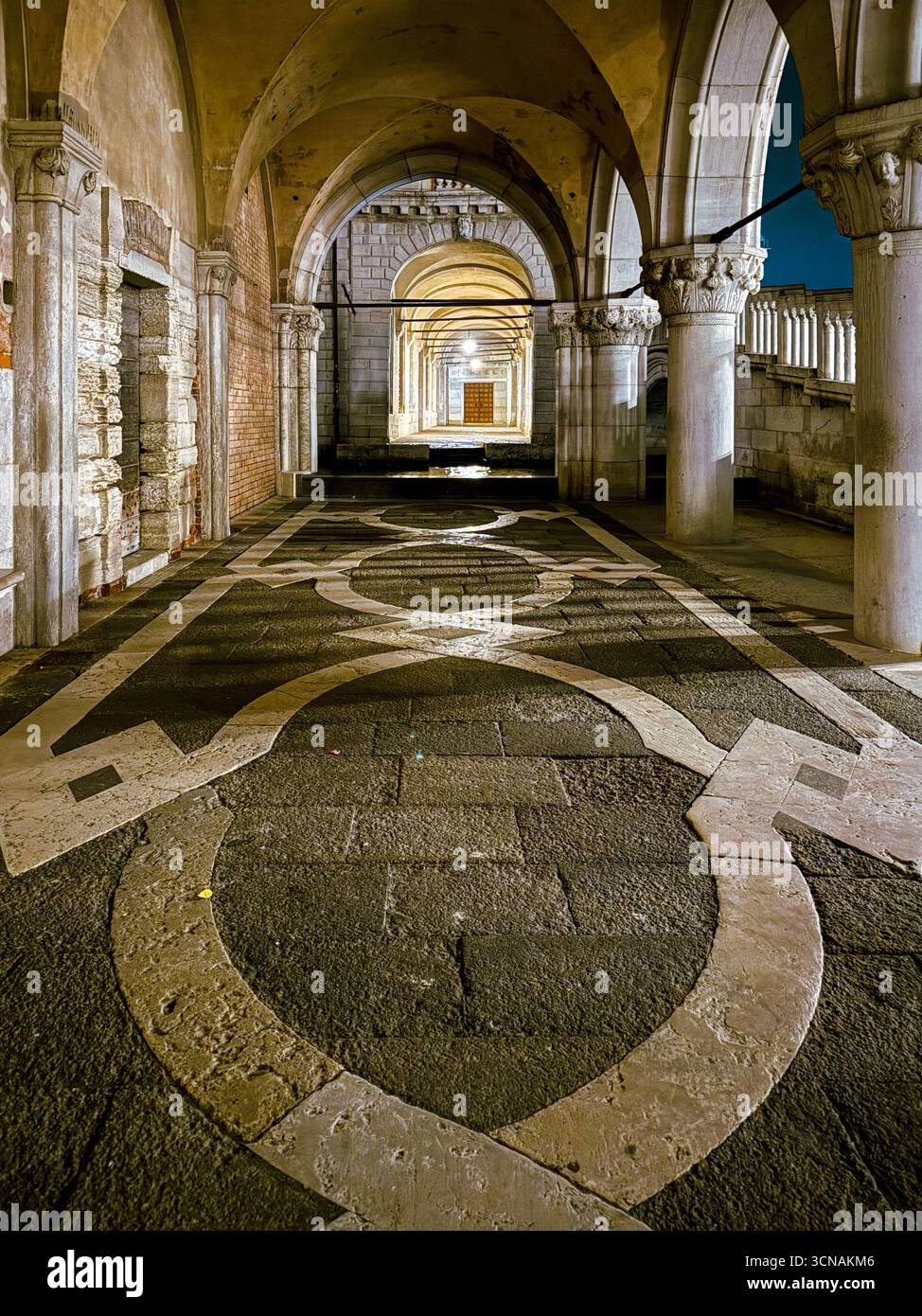 Night view of the arcades of the Doge's Palace and Prison's Palace, with Rio di Palazzo canal flowing through the middle, Venice, Veneto, Italy - Smartphone Captured Stock Image