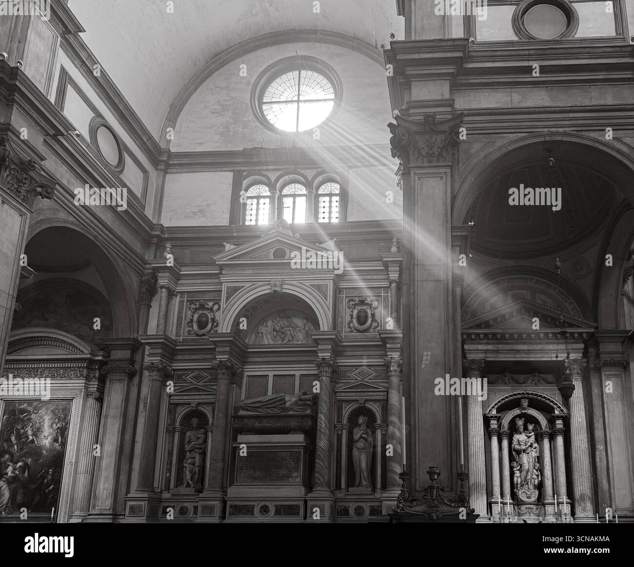 B&W. Detail of the interior of the church of San Salvador, with rays of sunlight coming through the windows, Venice, Veneto, Italy - Smartphone Captured Stock Image