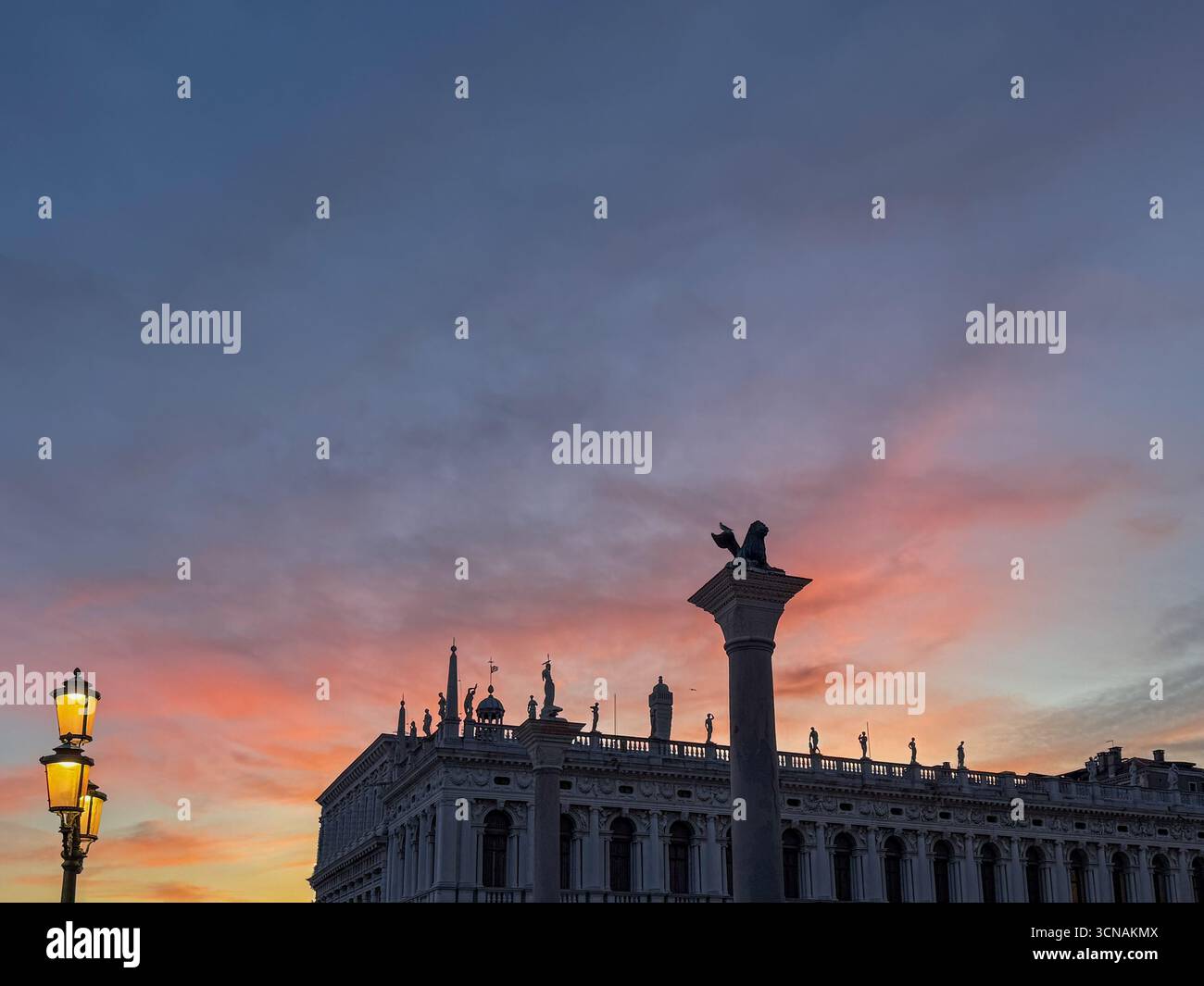 High-section of the Columns of St Mark and St Todaro in Piazzetta San Marco, with the Marciana Library in the background, at sunset, Venice, Italy - Smartphone Captured Stock Image