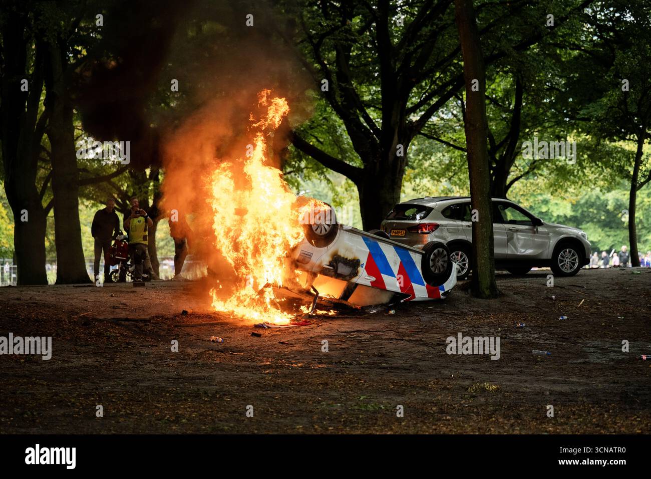 THE HAGUE - A police car is set on fire during a protest against the ...