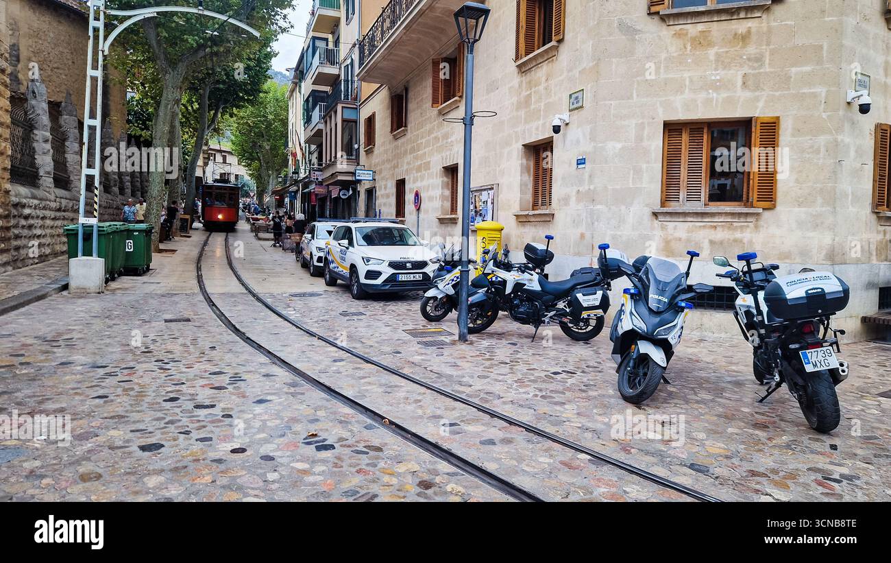 Soller, Spain - September 6 2025: Spanish Police cars and motorbikes on Soller Mallorca city street. - Smartphone Captured Stock Image