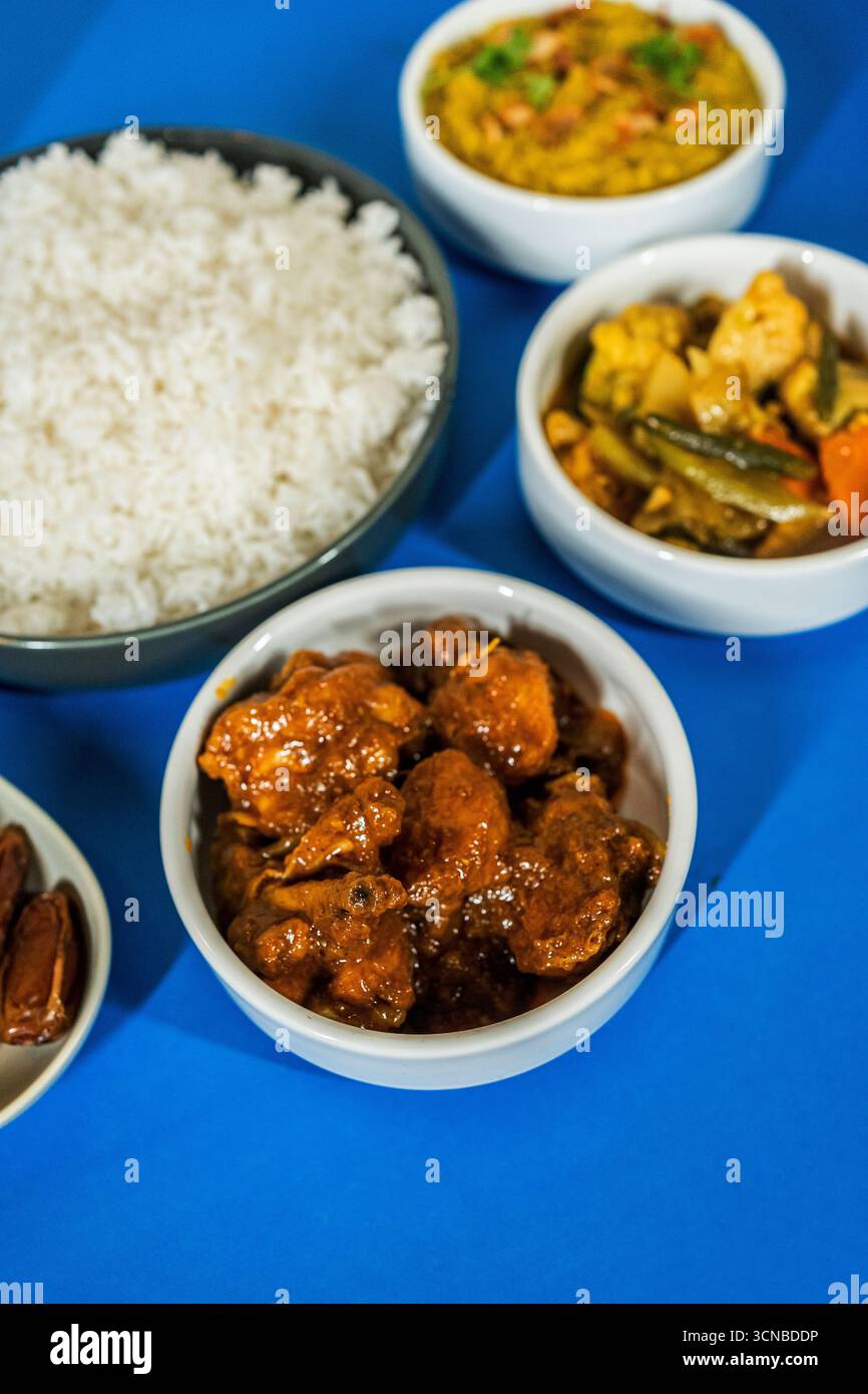 A high-angle shot of a traditional South Asian meal, featuring a bowl ...