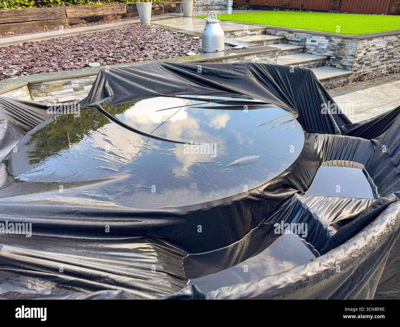 Water standing on the cover of a garden table after heavy rain from a storm. No people. - Smartphone Captured Stock Image