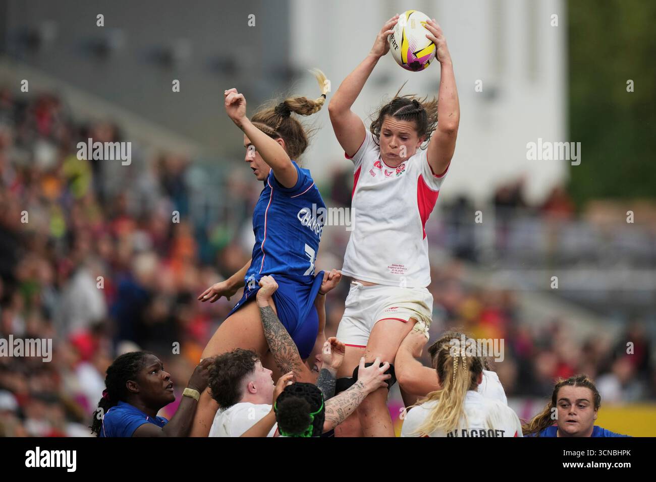 England's Morwenna Talling, right, grabs the ball past France's Lea ...