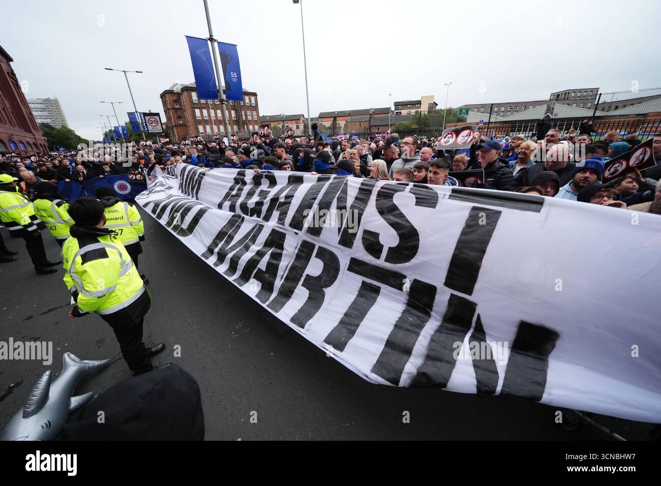 Campaigners hold signs opposing Rangers head coach Russell Martin and ...