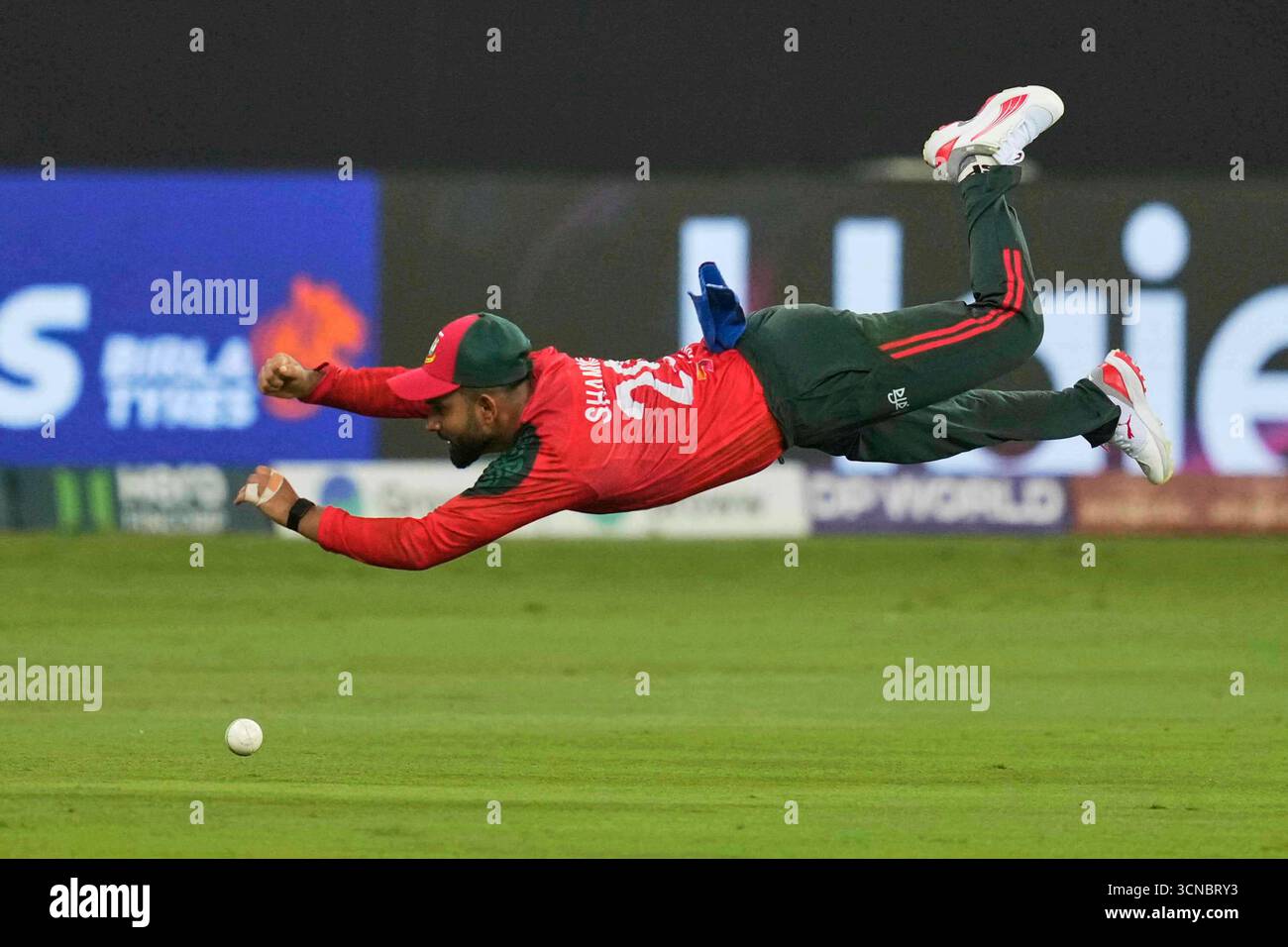 Bangladesh's Shamim Hossain dives in a failed attempt to catch the ball ...