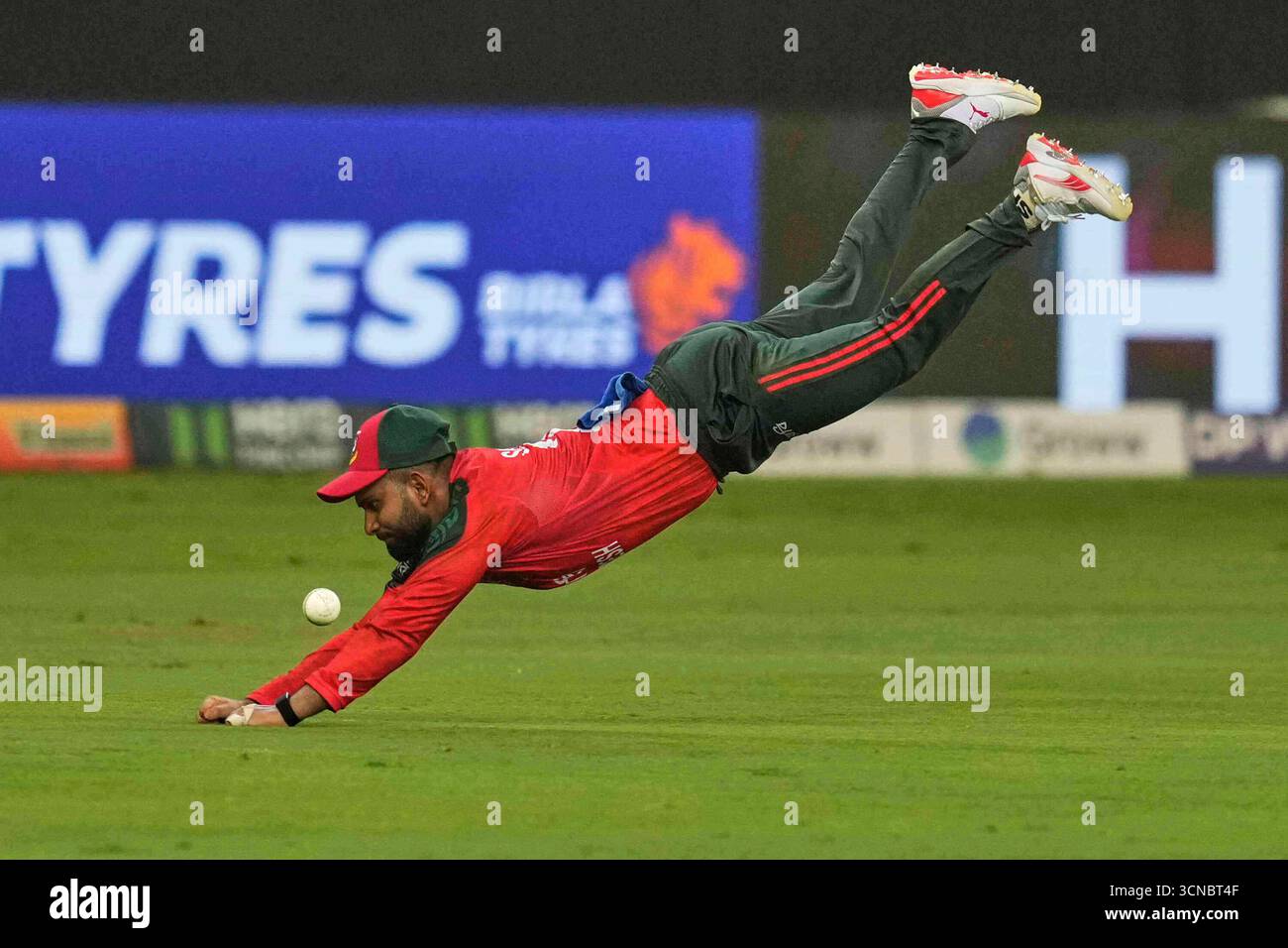 Bangladesh's Shamim Hossain dives in a failed attempt to catch the ball ...