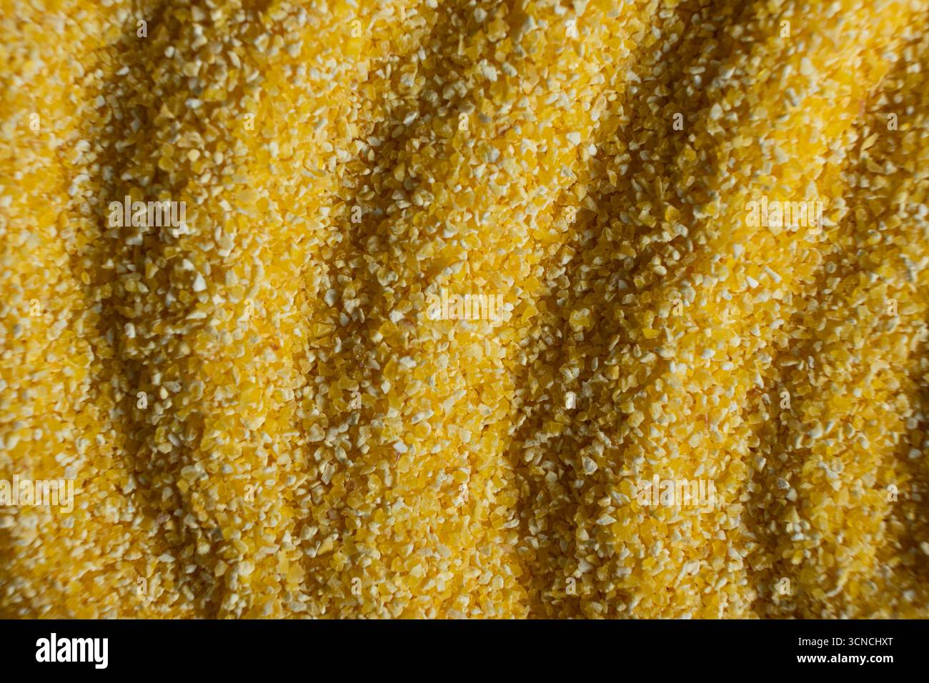 Abstract Yellow Cooking Corn Grits Background. Stock Photo