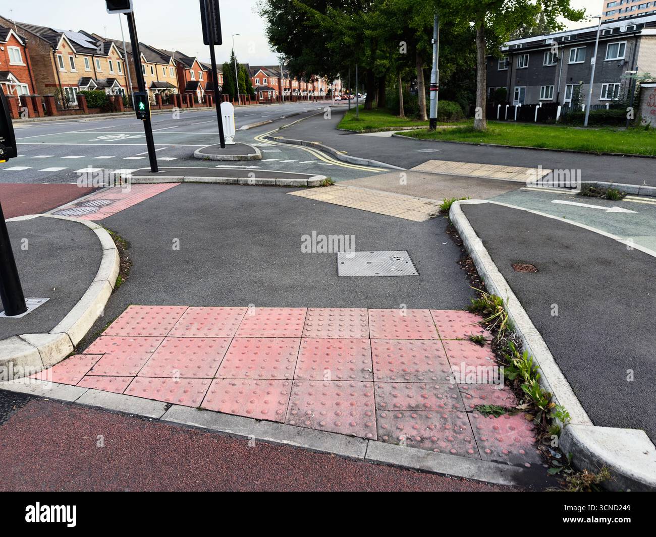 Tactile paving and pathways near a pedestrian crossing in urban setting ...