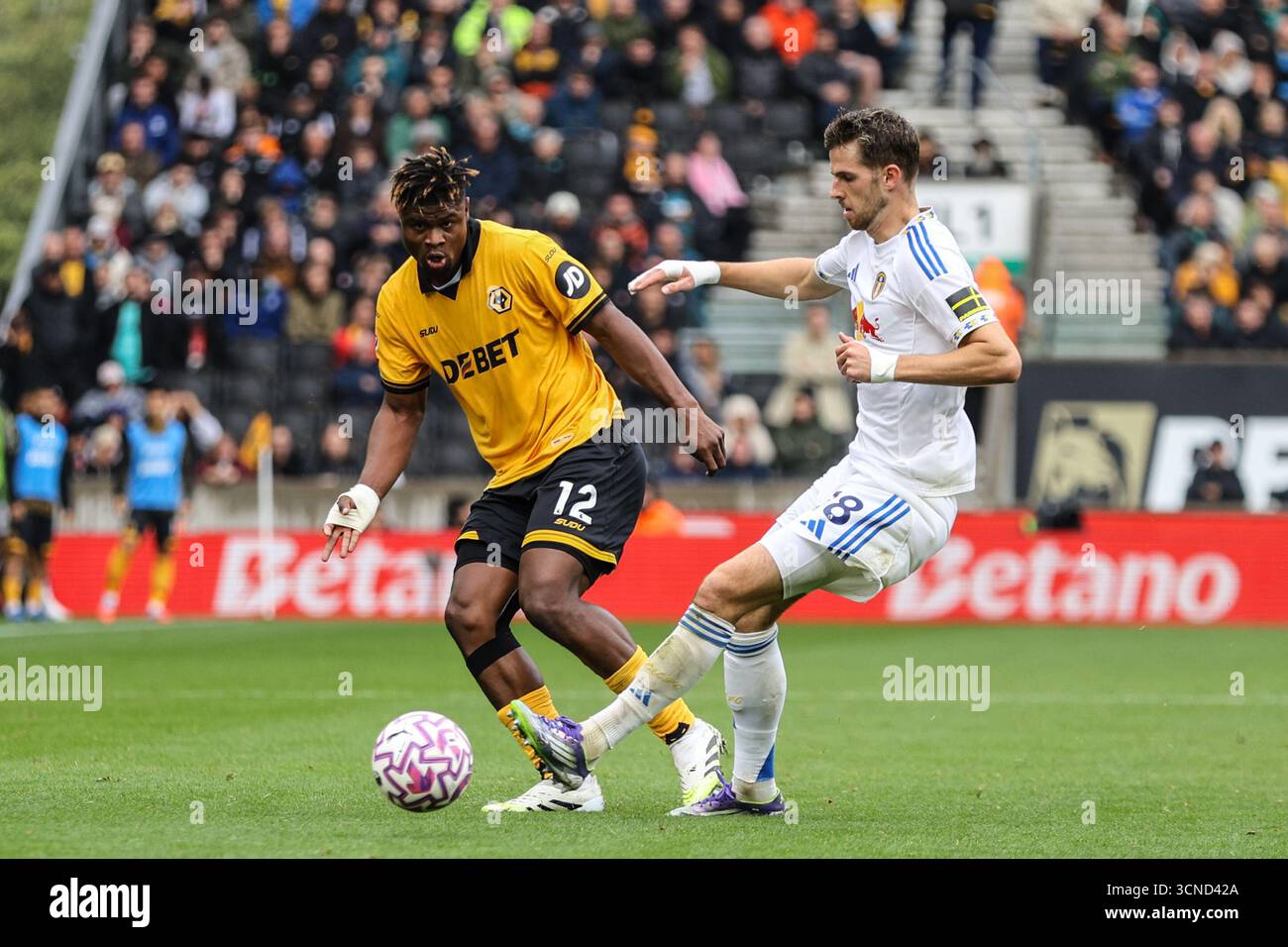Emmanuel Agbadou (12 Wolves) and Anton Stach (18 Leeds) battle for the ...