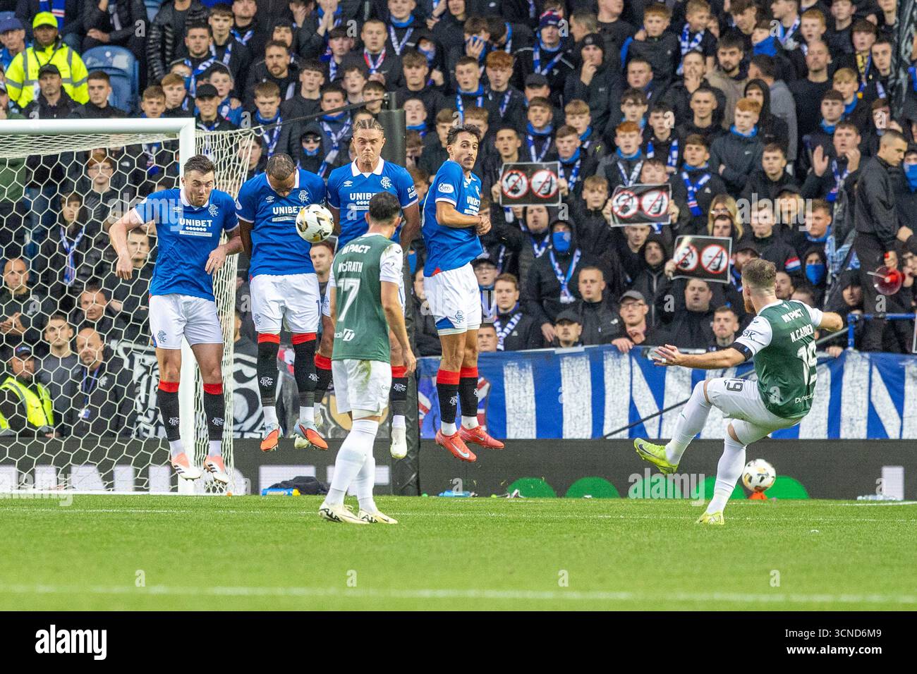 Glasgow, UK. 20th Sep, 2025. Rangers FC played Hibernian FC at Ibrox stadium, Glasgow, Scotland, in a Premier Sports Cup game. The final score was Rangers 2 - 0 Hibernian. Nicolas Cadden (H19) takes a free kick and it is blocked by the 4 man Rangers wall. Credit: Findlay/Alamy Live News Stock Photo