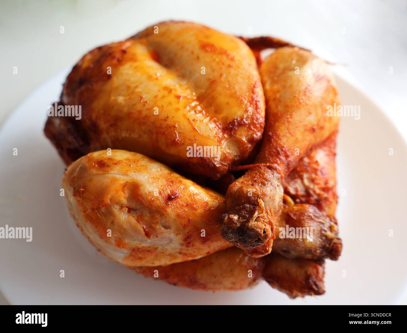 Plate of golden roasted chicken pieces with crispy skin, perfect for family dinners or quick weeknight meals. A warm, savory dish with comforting Stock Photo