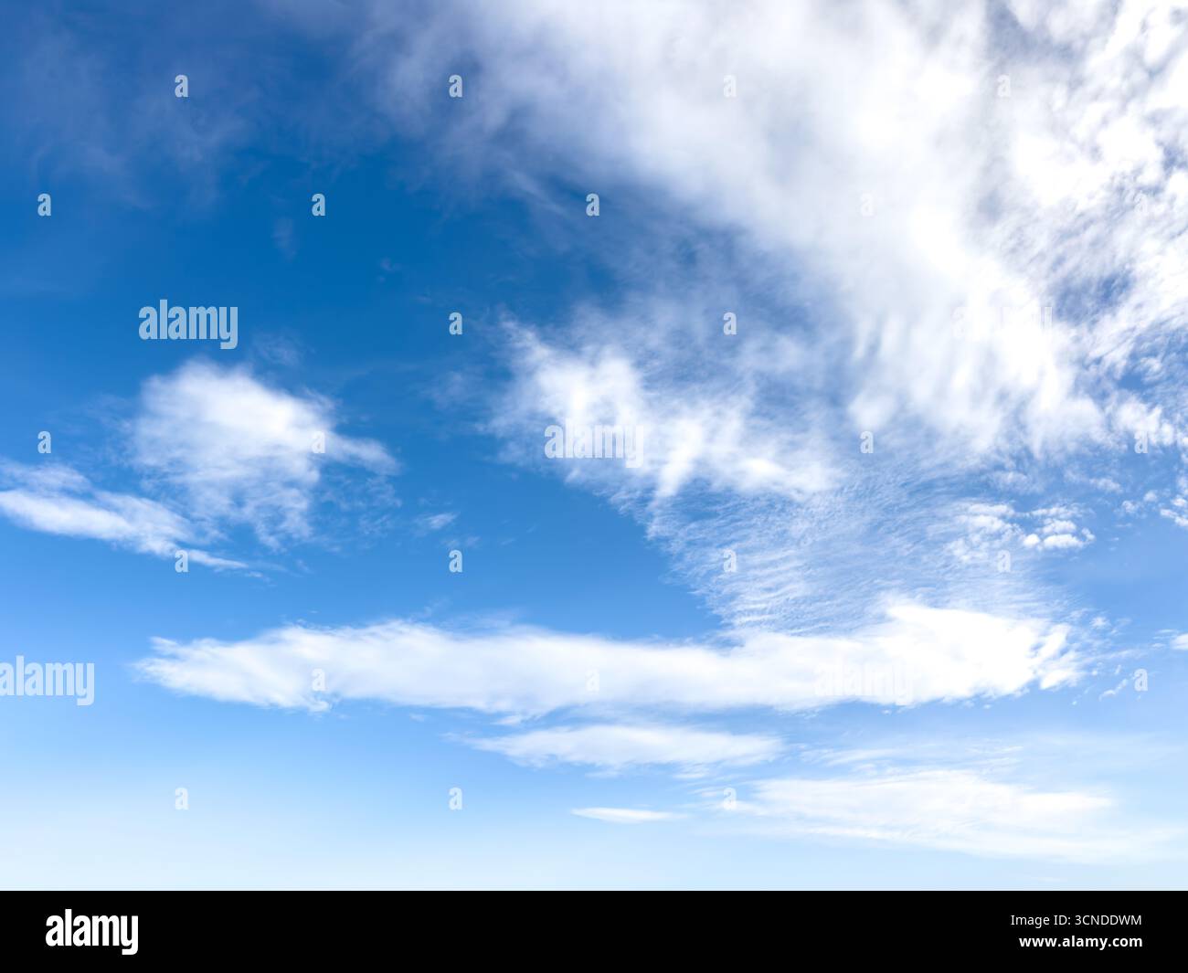 Clear blue sky with high scattered cirro-cumulus white clouds on a sunny day. copyspace - Smartphone Captured Stock Image
