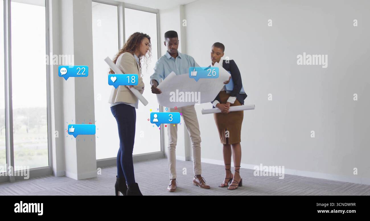 Three architects in suits analyzing architectural plans by office windows, with social media icons Stock Photo