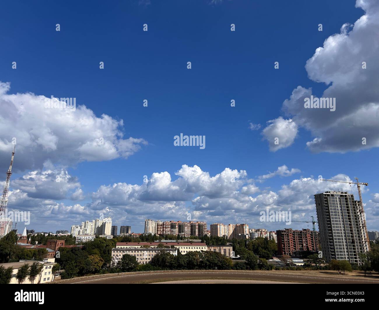 panorama of architecture and skyscrapers with a blue summer sky and white fluffy clouds - Smartphone Captured Stock Image