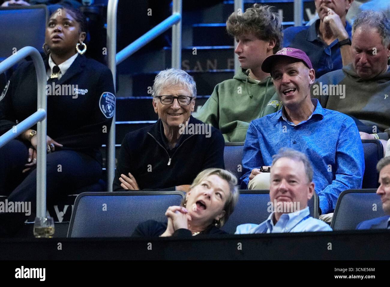 Bill Gates, middle, watches a match between Team Europe's Holger Rune ...