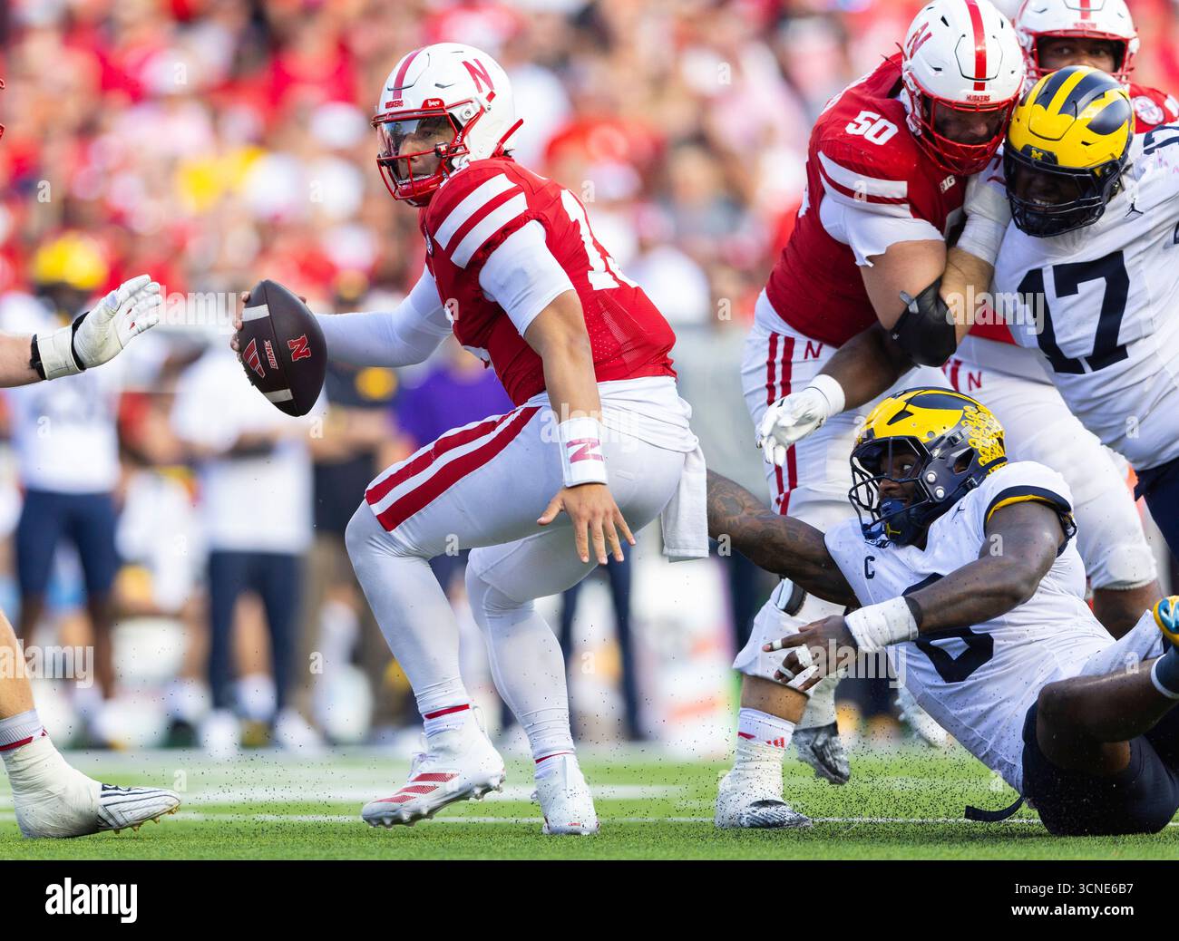 Michigan's Derrick Moore, right, tackles Nebraska quarterback Dylan ...