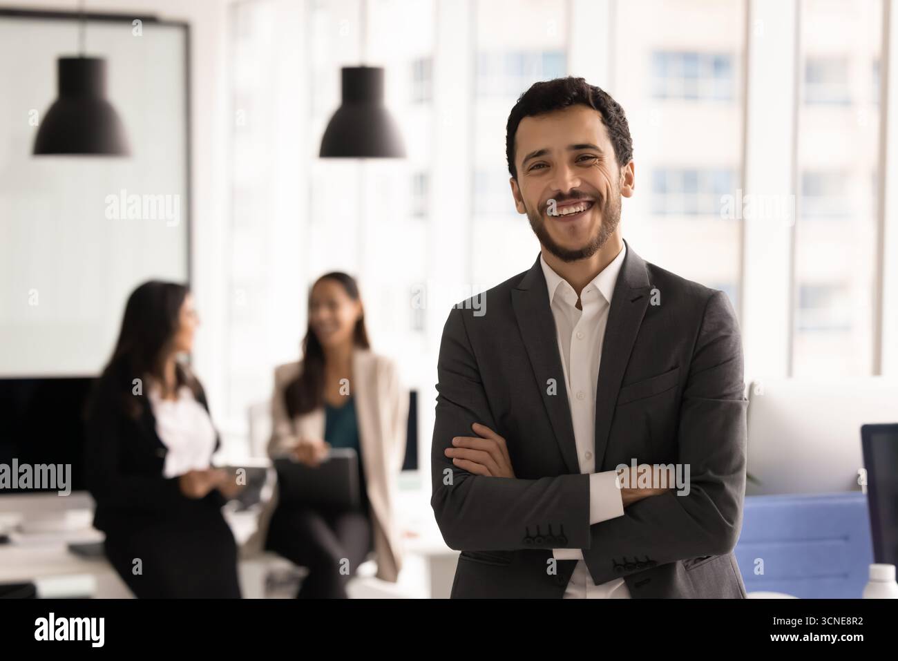 Happy young business leader man posing in office Stock Photo