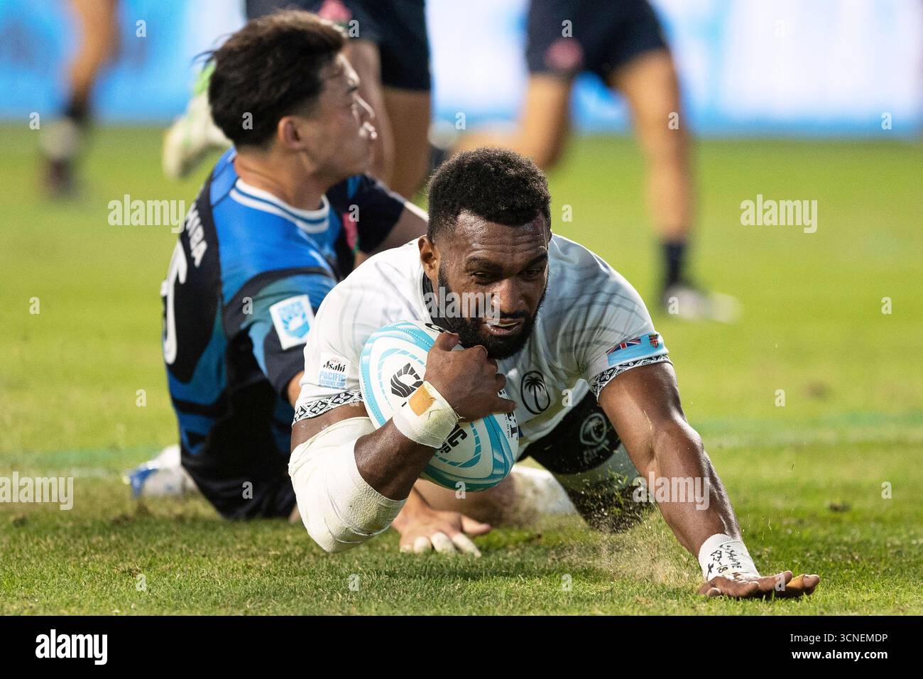 Fiji's Joji Nasova scores against Japan's Dylan Riley during the first ...