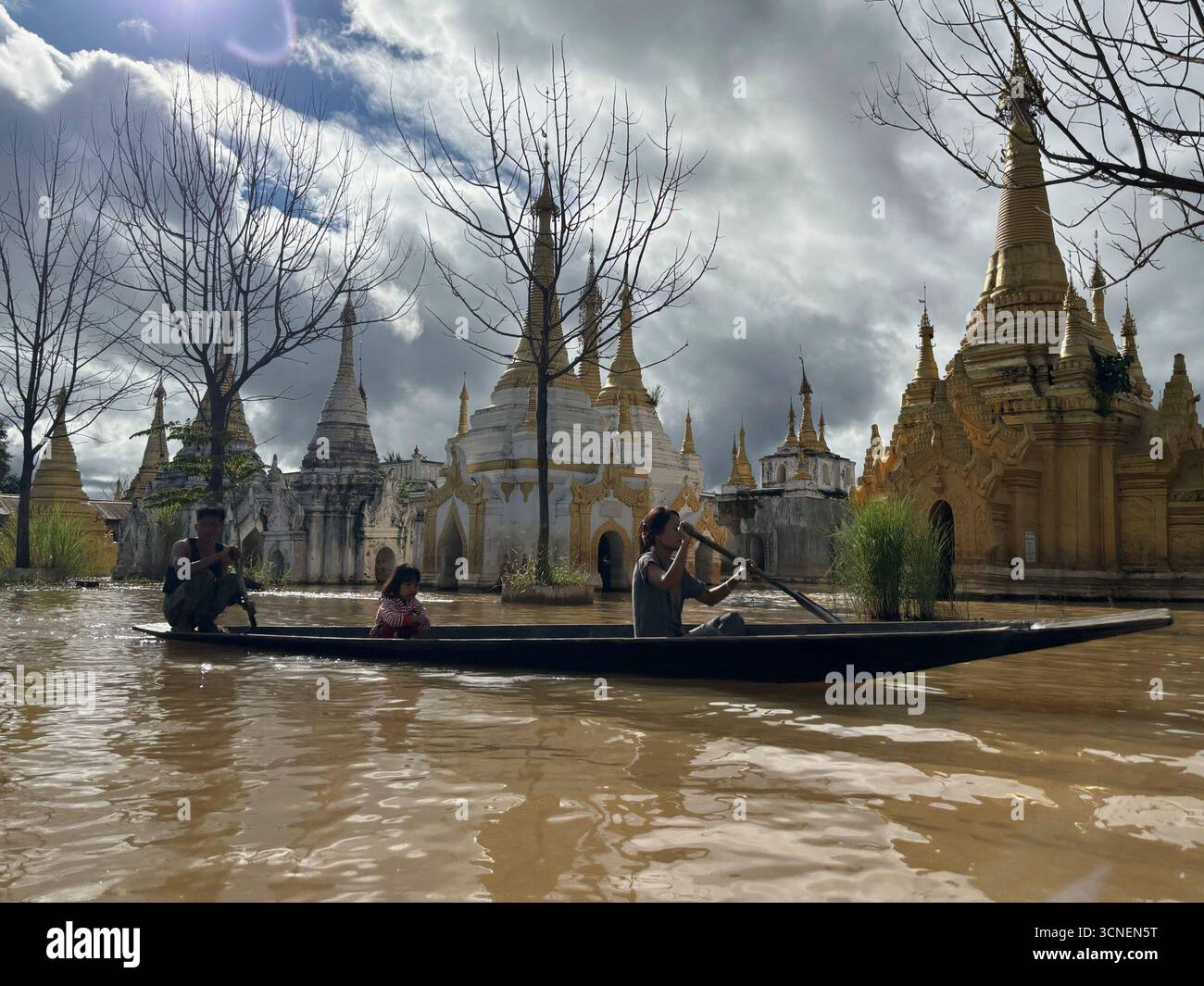 Ethnic Inntha people row a boat near pagodas Sunday, Sept. 21, 2025, in ...
