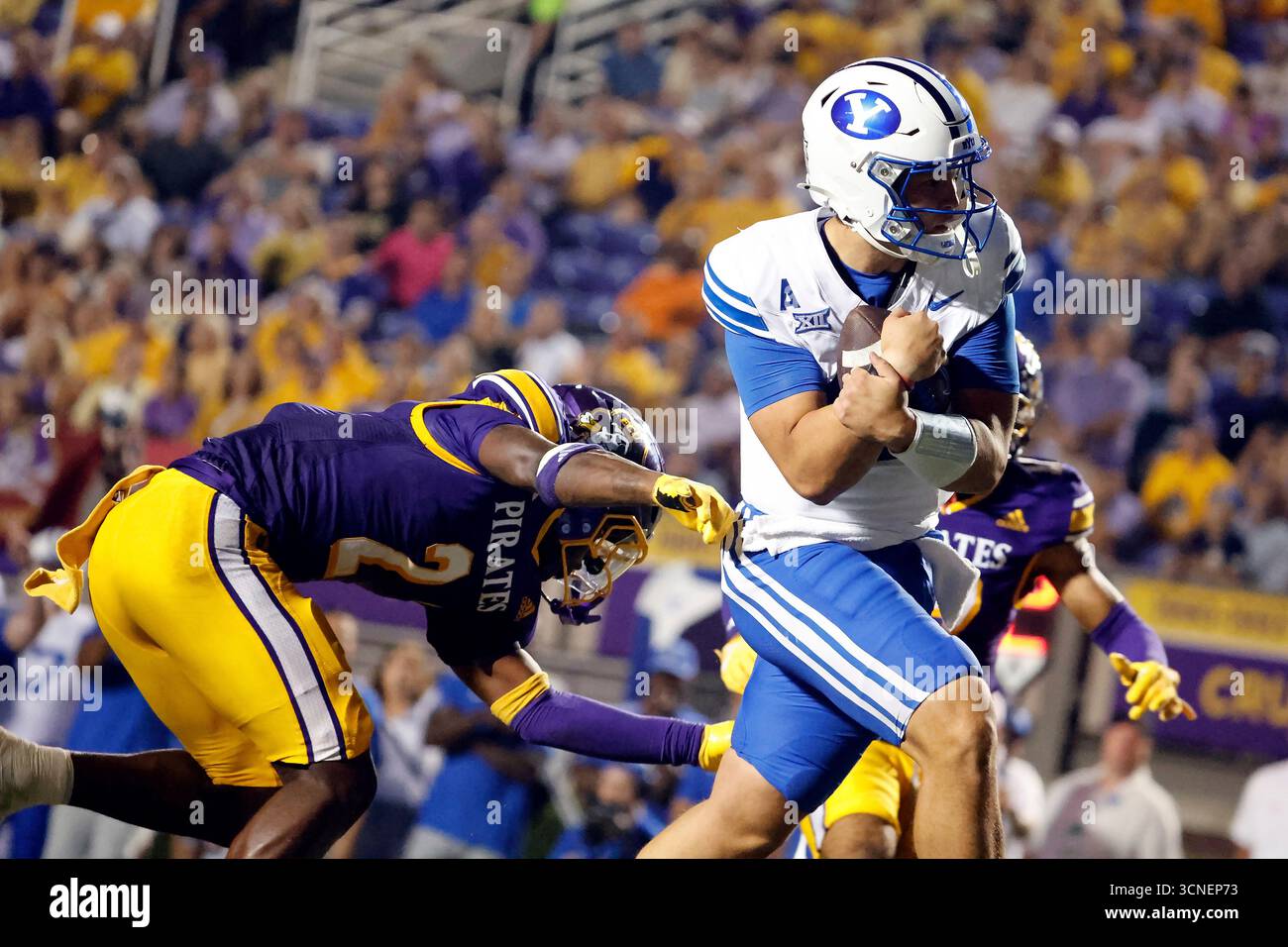 BYU quarterback Bear Bachmeier, right, breaks a tackle of East Carolina ...