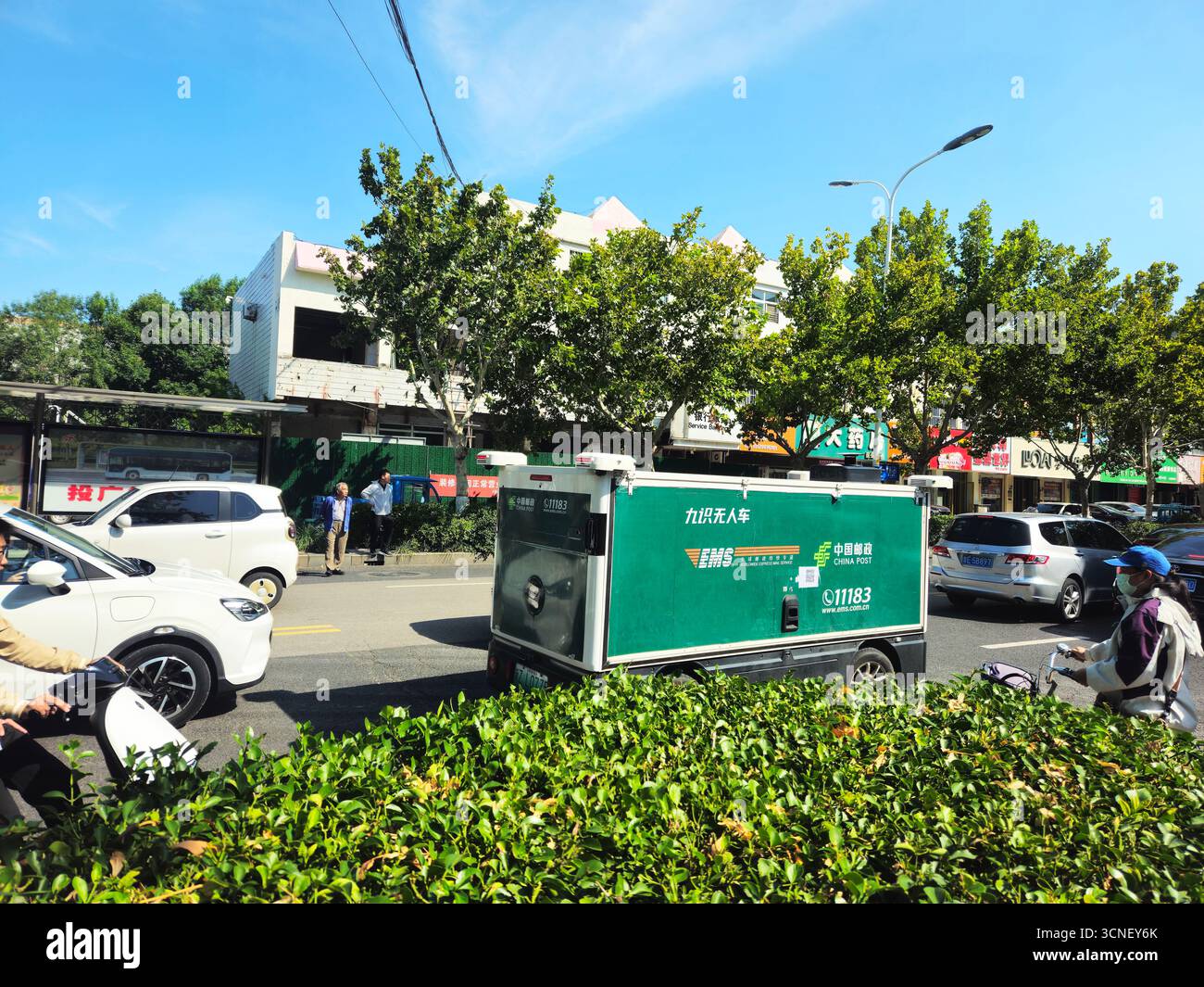 China Post EMS Unmanned Delivery Vehicle on City Street in Dongying, Shandong, China Stock Photo