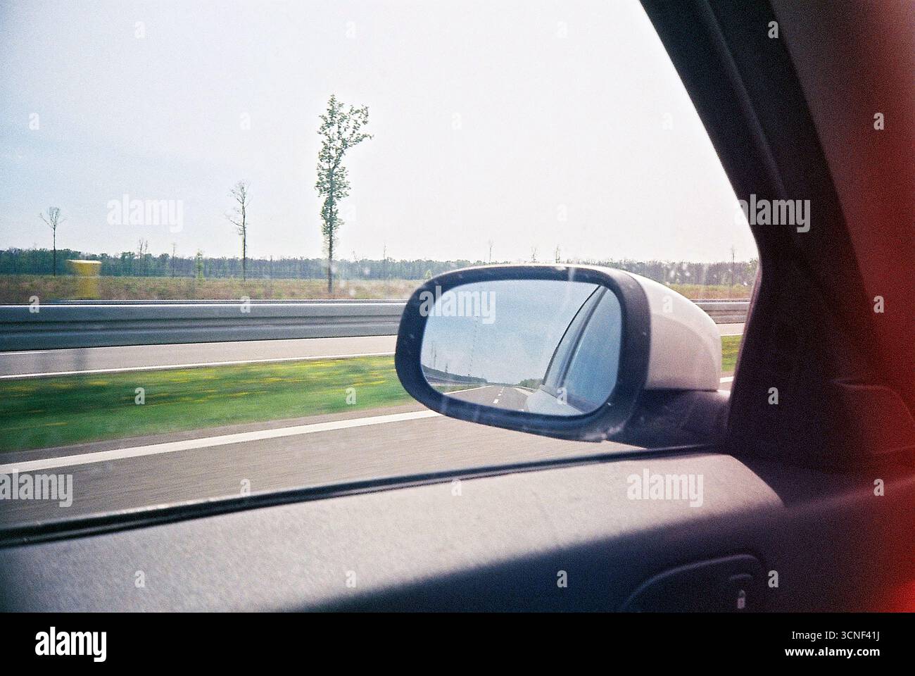 Analog archive photo of farmland landscape seen from a moving car. Side ...