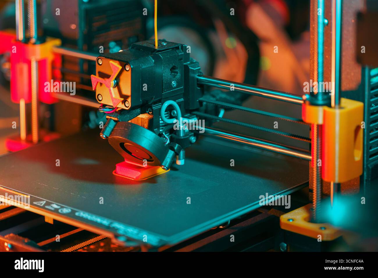 3D printer printing object modern prototyping process with visible extruder, moving axis and plastic filament deposition in high-tech engineering work Stock Photo