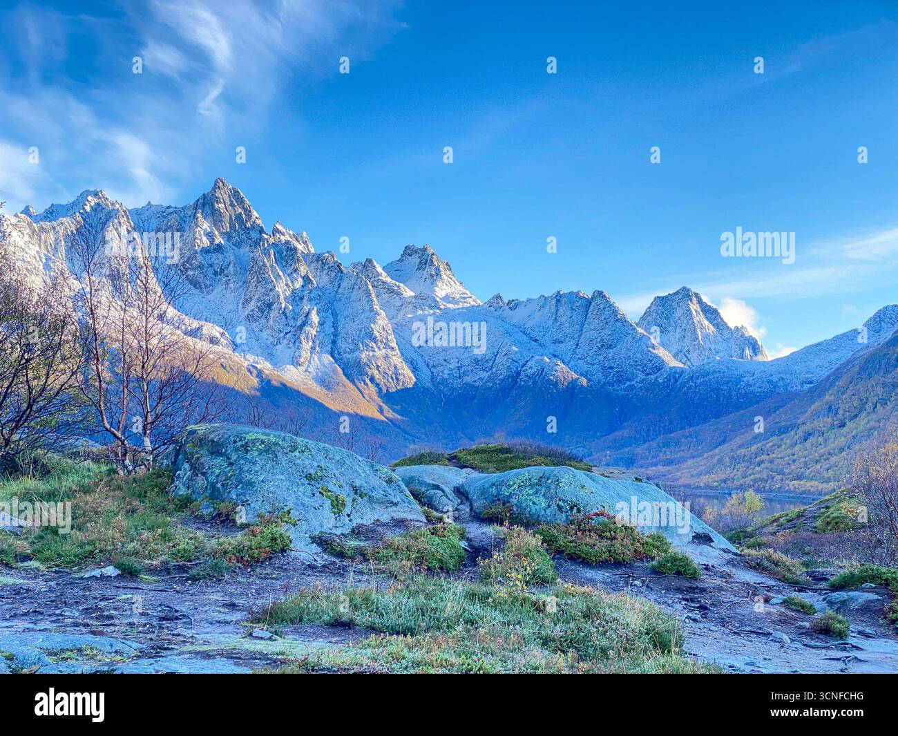 Autumn view from the E10 highway of the Austnesfjorden and Vestpollen with the snow-capped mountain of Higravtindan, It is the highest mountain on the - Smartphone Captured Stock Image