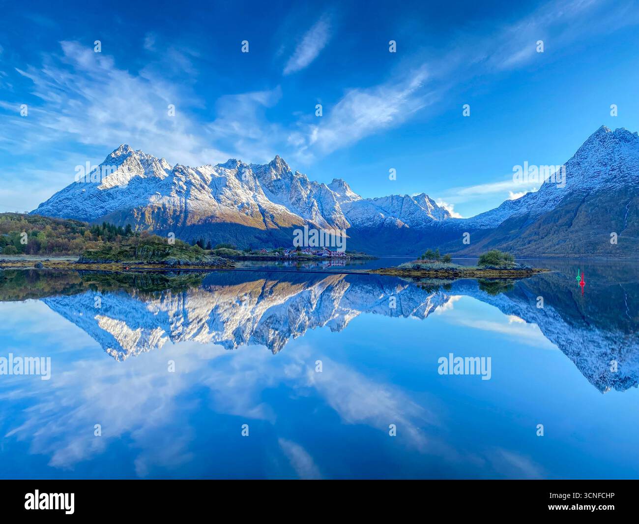 Autumn view from the E10 highway of the Austnesfjorden and Vestpollen with the snow-capped mountain of Higravtindan, It is the highest mountain on the - Smartphone Captured Stock Image