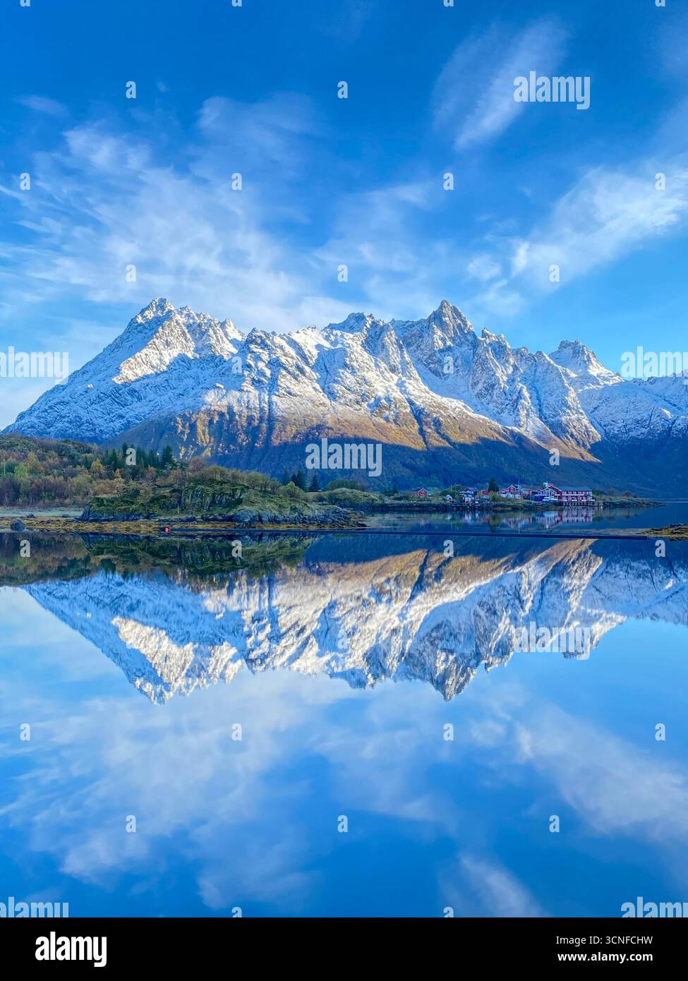 Autumn view from the E10 highway of the Austnesfjorden and Vestpollen with the snow-capped mountain of Higravtindan, It is the highest mountain on the - Smartphone Captured Stock Image
