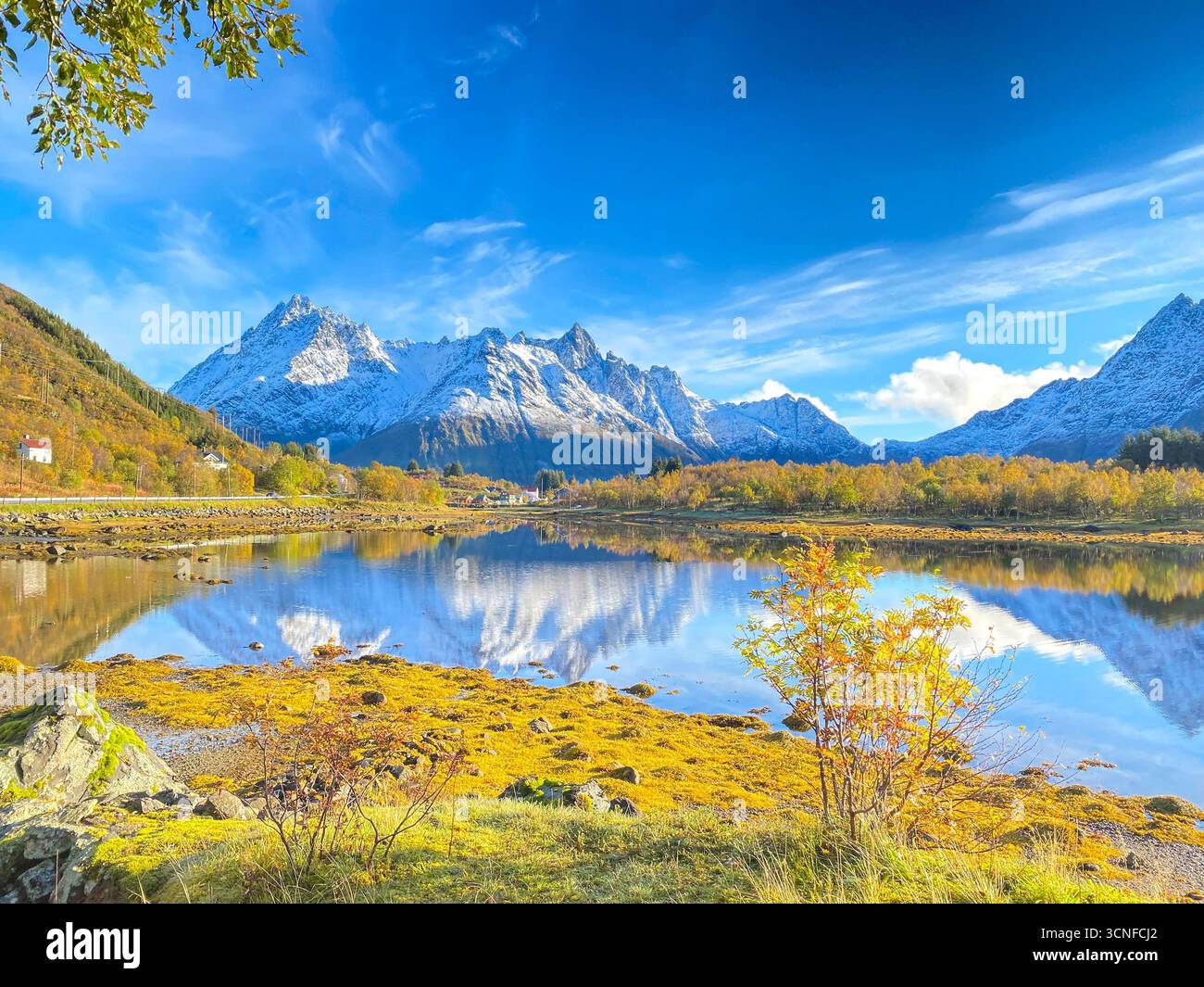 Autumn view from the E10 highway of the Austnesfjorden and Vestpollen with the snow-capped mountain of Higravtindan, It is the highest mountain on the - Smartphone Captured Stock Image