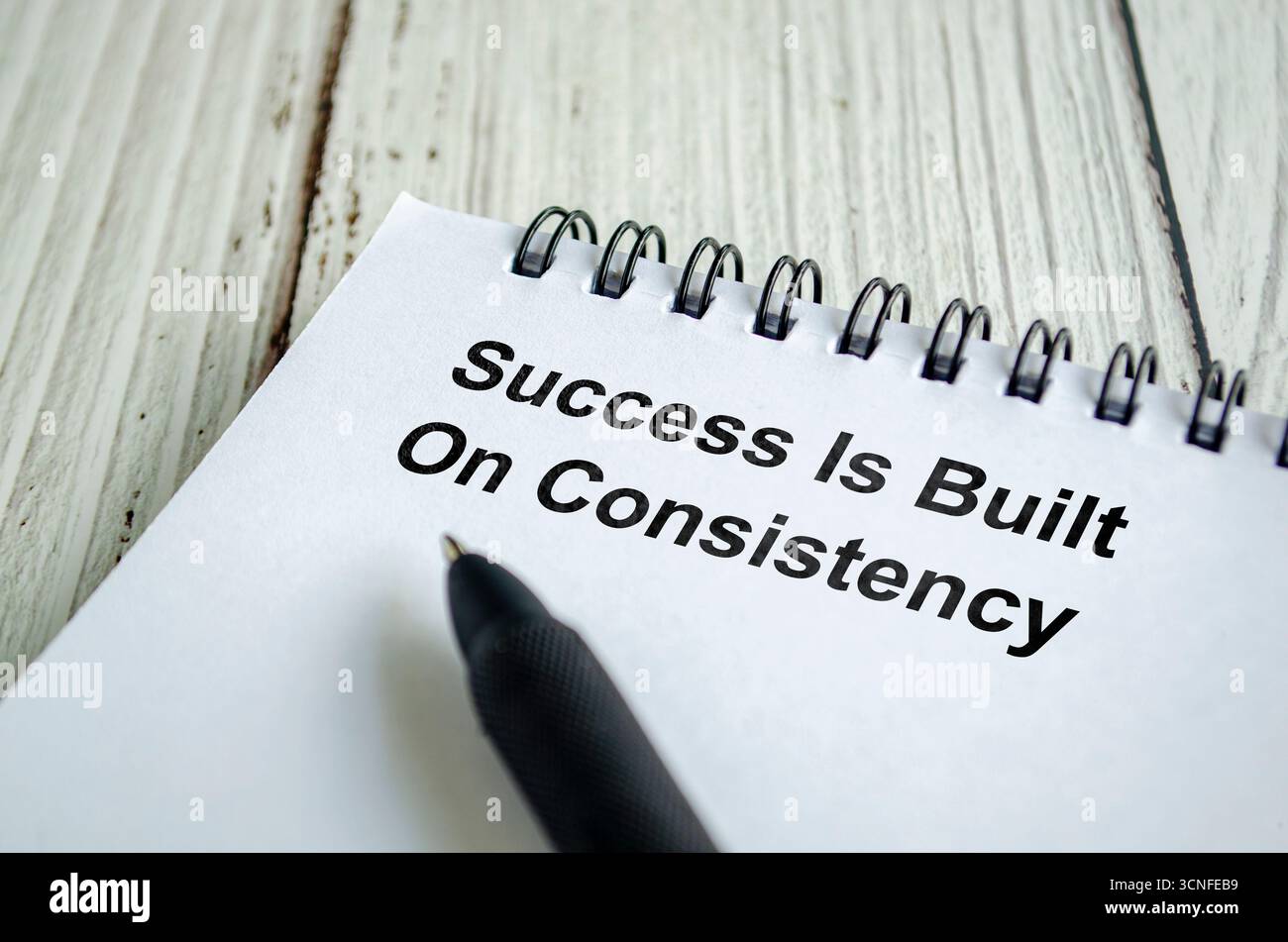 Success is built on consistency text written on a spiral notepad with ...