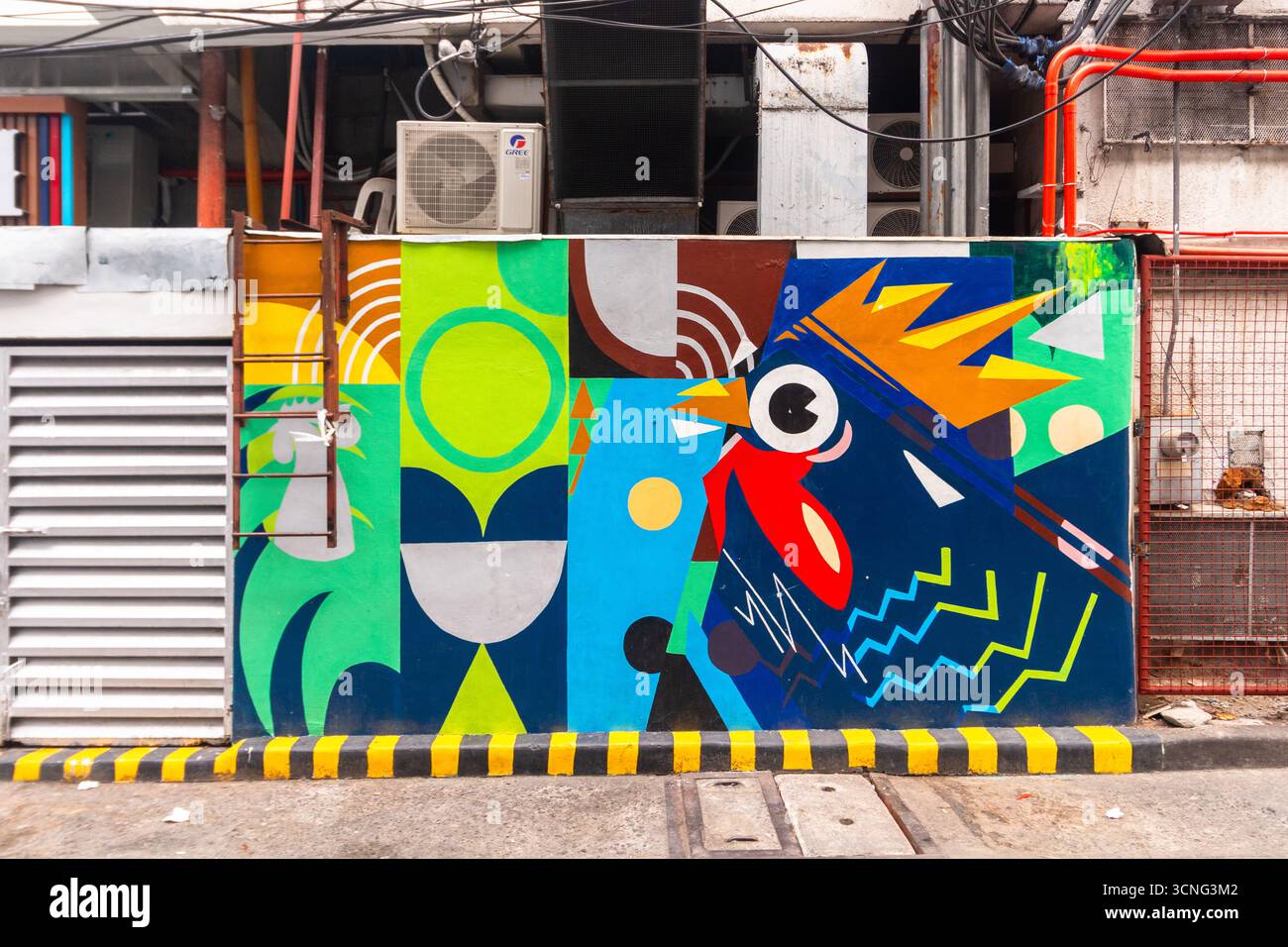 Colorful rooster wall mural by a local artist along a street in Makati City, Philippines Stock Photo