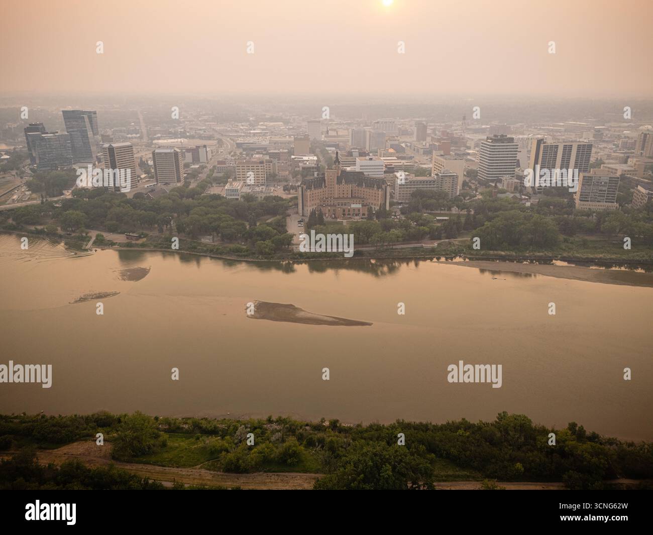 Aerial view of downtown Saskatoon, Saskatchewan, with wildfire smoke hazing the skyline and river valley. Stock Photo