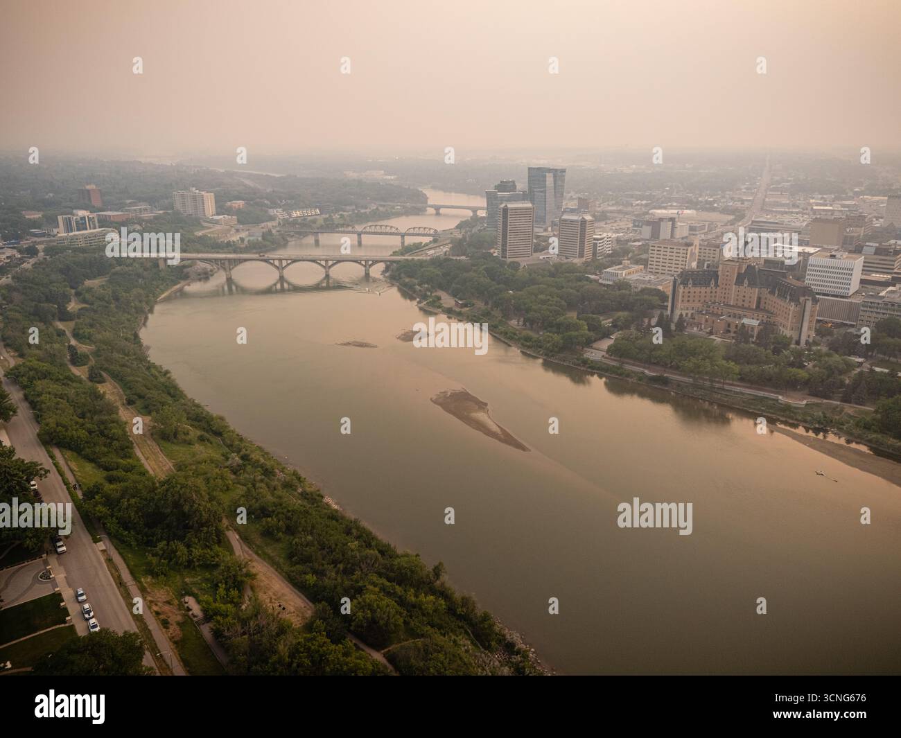 Aerial view of downtown Saskatoon, Saskatchewan, with wildfire smoke hazing the skyline and river valley. Stock Photo
