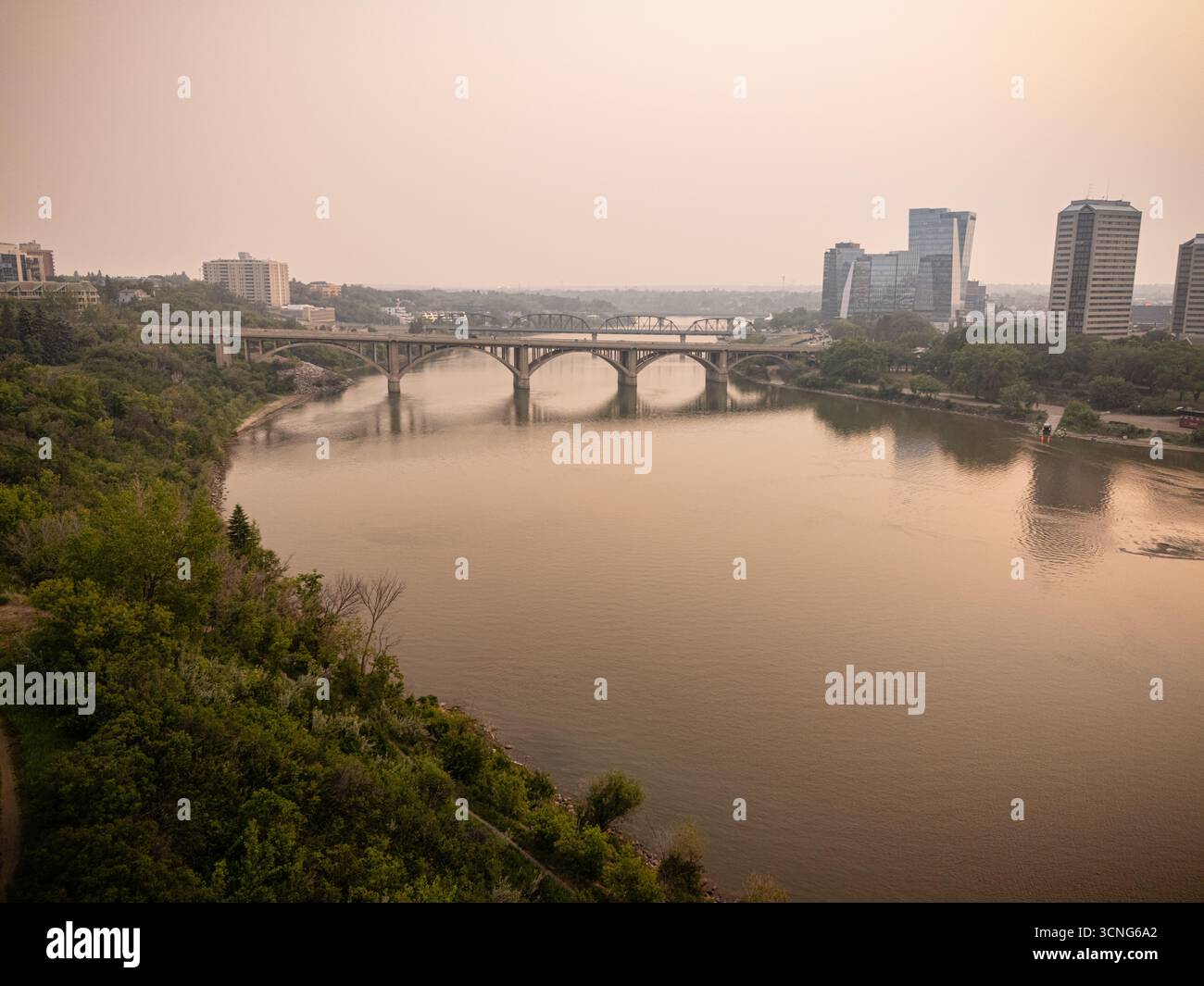 Aerial view of downtown Saskatoon, Saskatchewan, with wildfire smoke hazing the skyline and river valley. Stock Photo