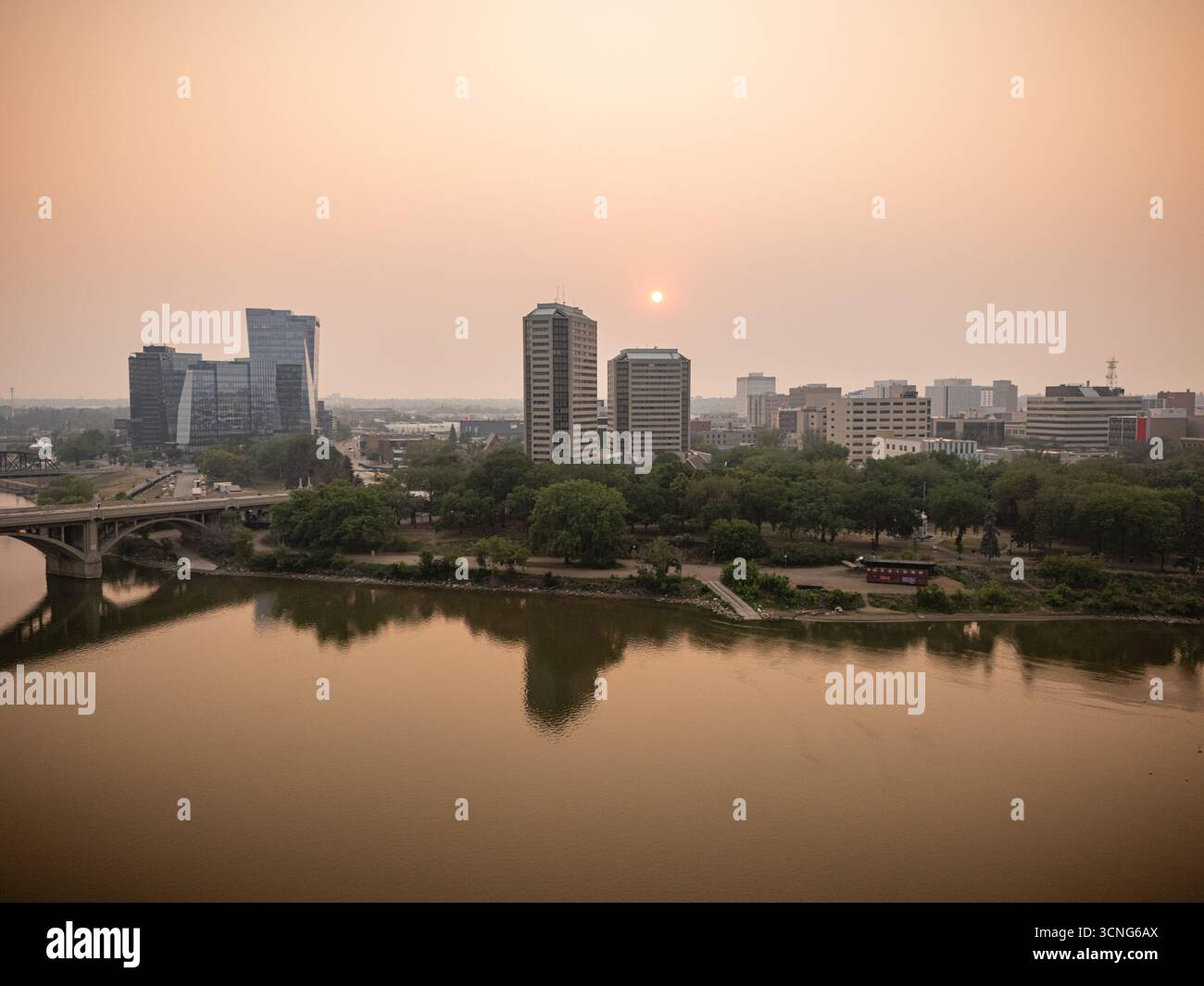Aerial view of downtown Saskatoon, Saskatchewan, with wildfire smoke hazing the skyline and river valley. Stock Photo