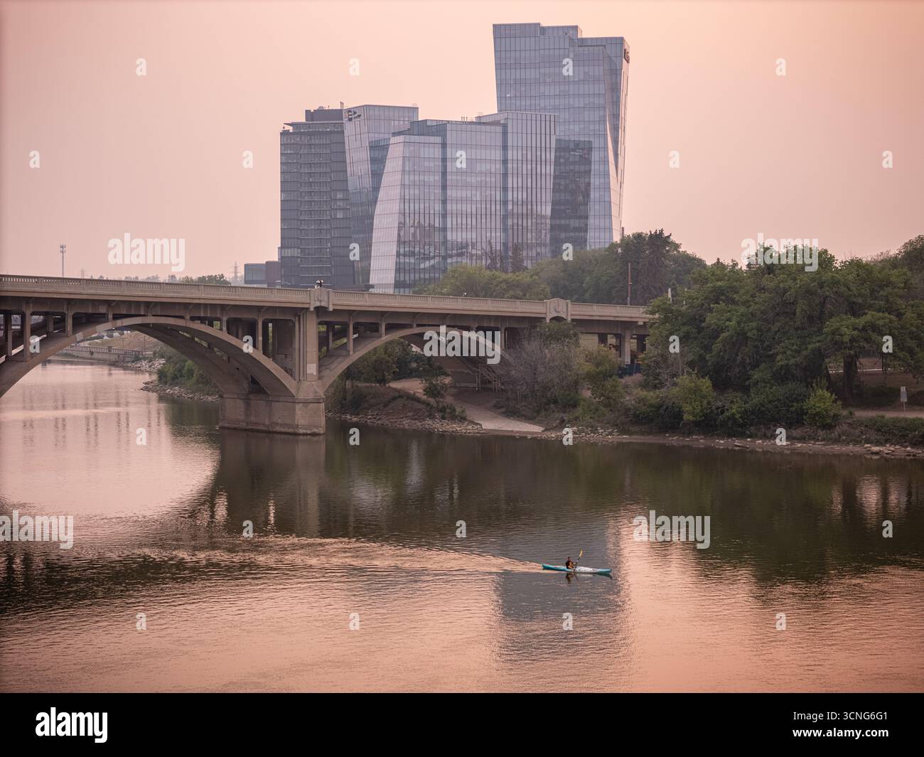 Aerial view of downtown Saskatoon, Saskatchewan, with wildfire smoke hazing the skyline and river valley. Stock Photo