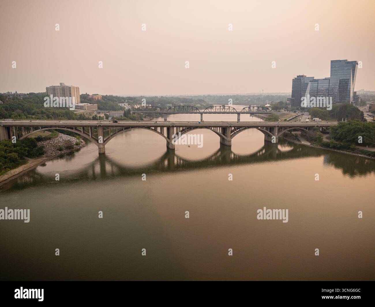 Aerial view of downtown Saskatoon, Saskatchewan, with wildfire smoke hazing the skyline and river valley. Stock Photo