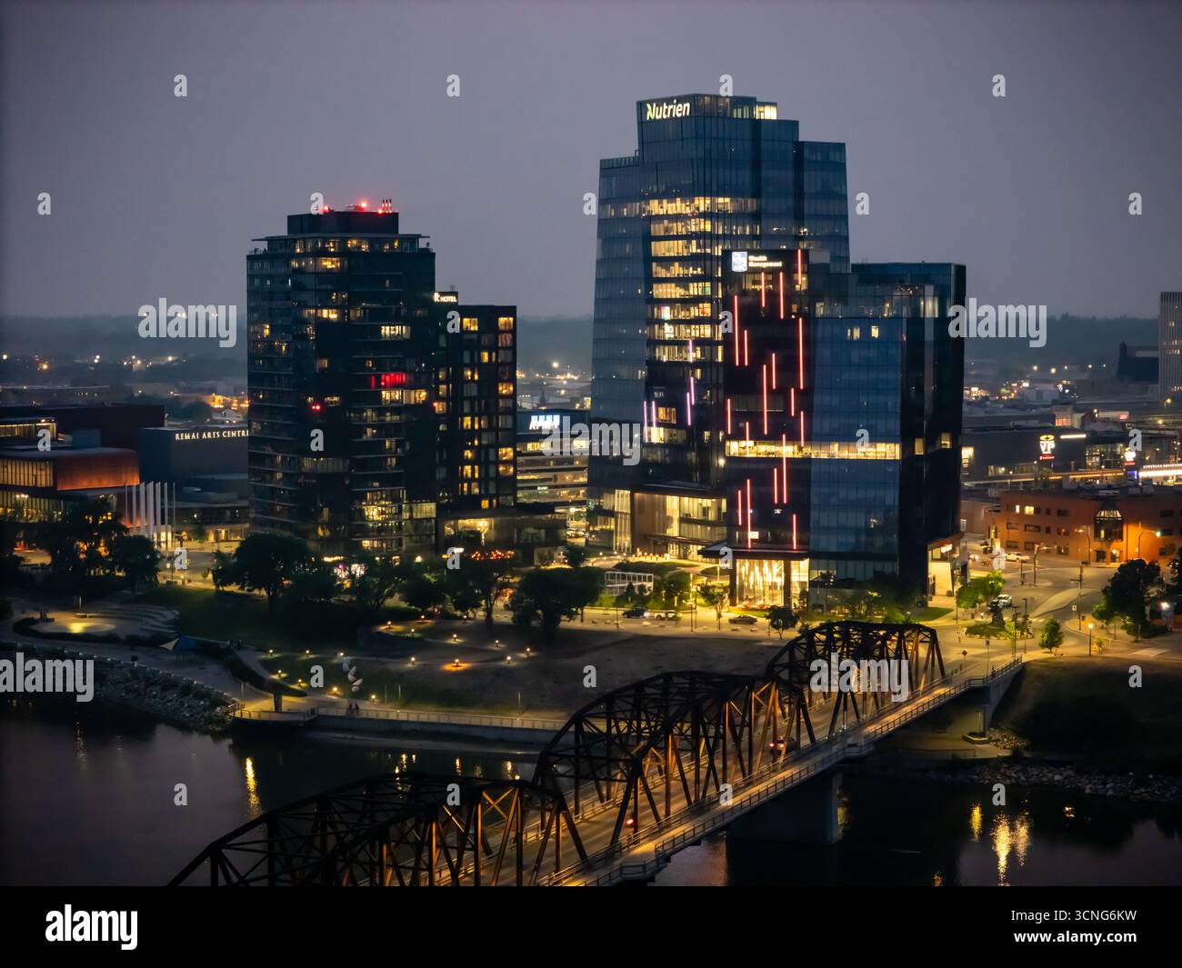 Aerial night view of downtown Saskatoon, Saskatchewan, featuring the city skyline, bridges, and illuminated streets. Stock Photo