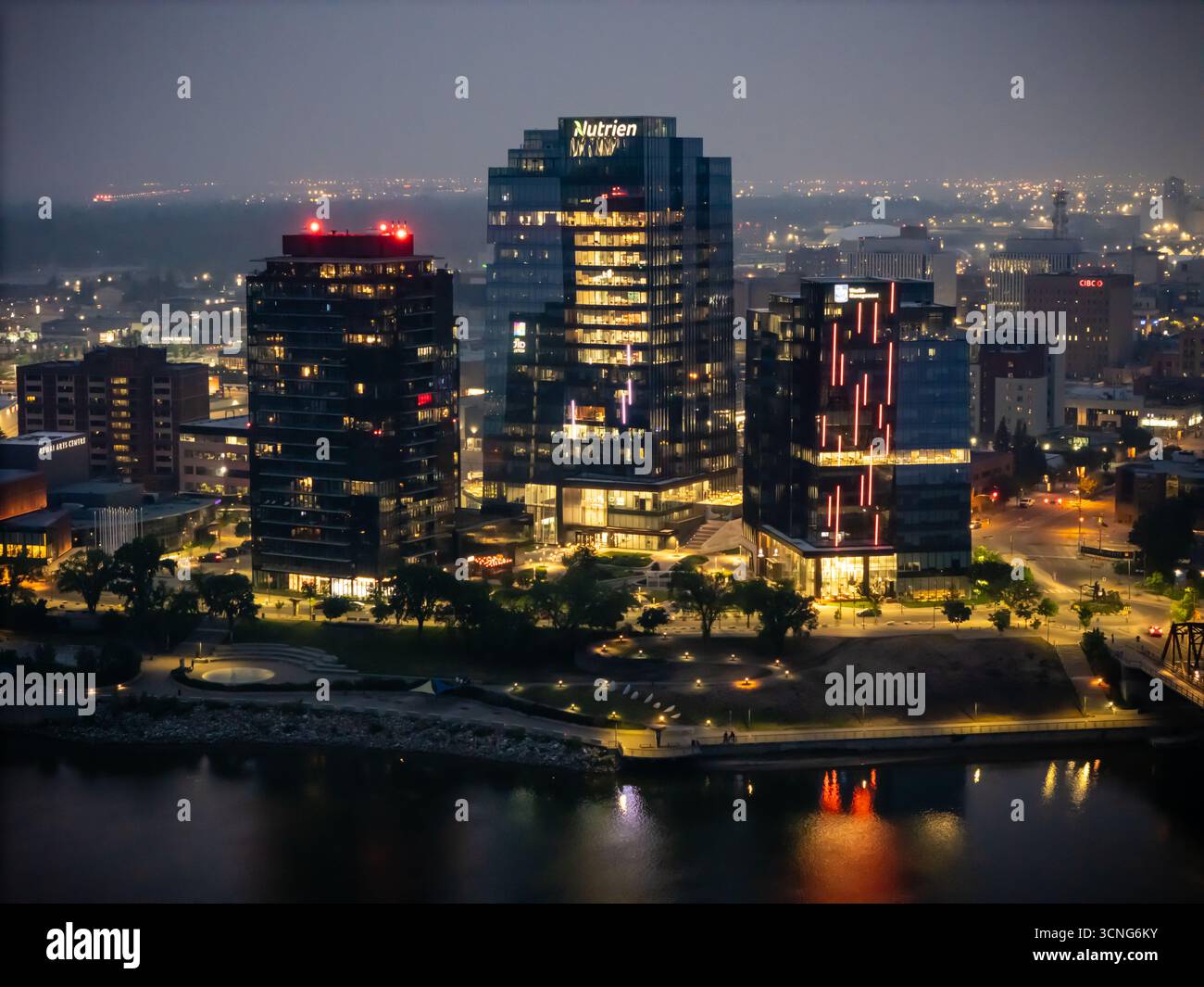 Aerial night view of downtown Saskatoon, Saskatchewan, featuring the city skyline, bridges, and illuminated streets. Stock Photo