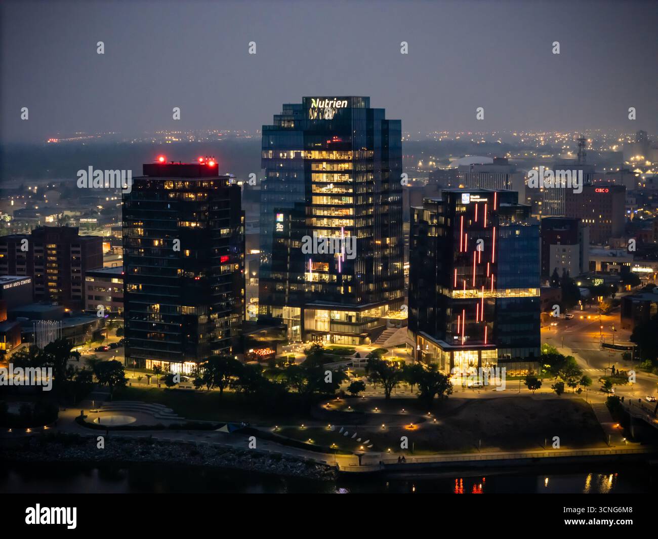 Aerial night view of downtown Saskatoon, Saskatchewan, featuring the city skyline, bridges, and illuminated streets. Stock Photo