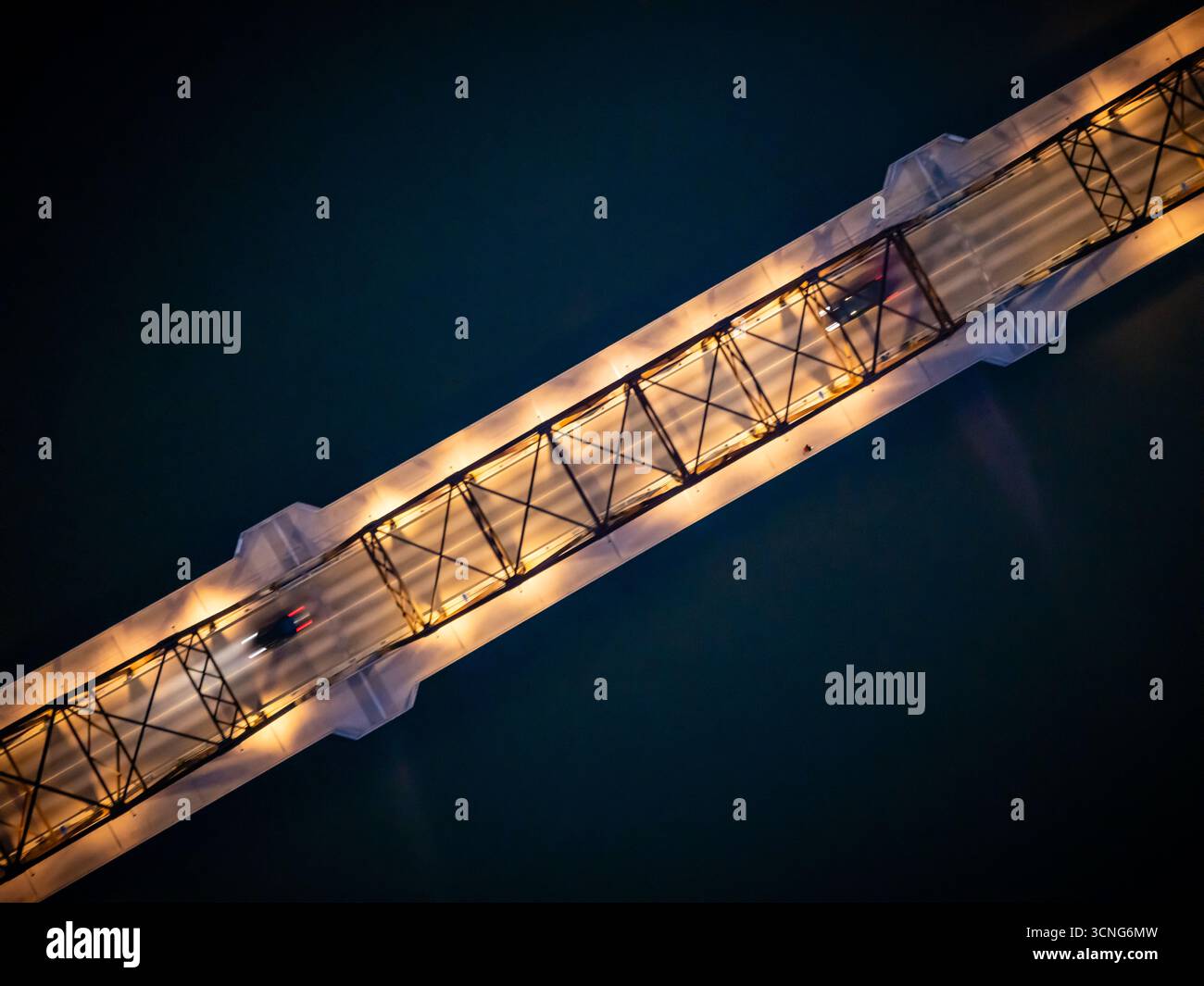 Aerial night view of the Traffic Bridge in Saskatoon, Saskatchewan, with city lights reflecting on the South Saskatchewan River. Stock Photo