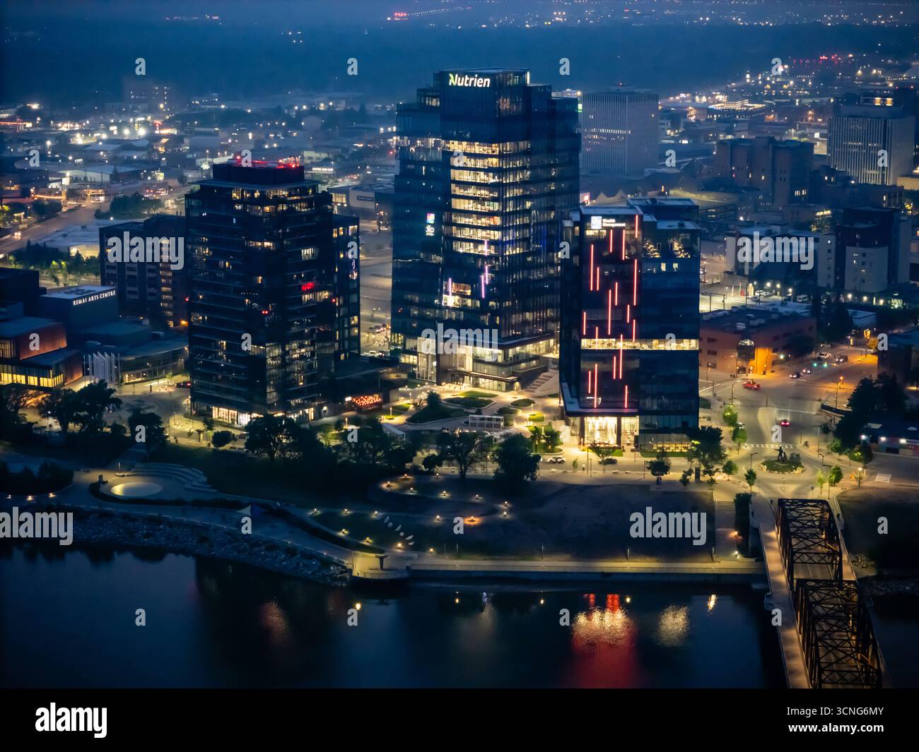 Aerial night view of downtown Saskatoon, Saskatchewan, featuring the city skyline, bridges, and illuminated streets. Stock Photo