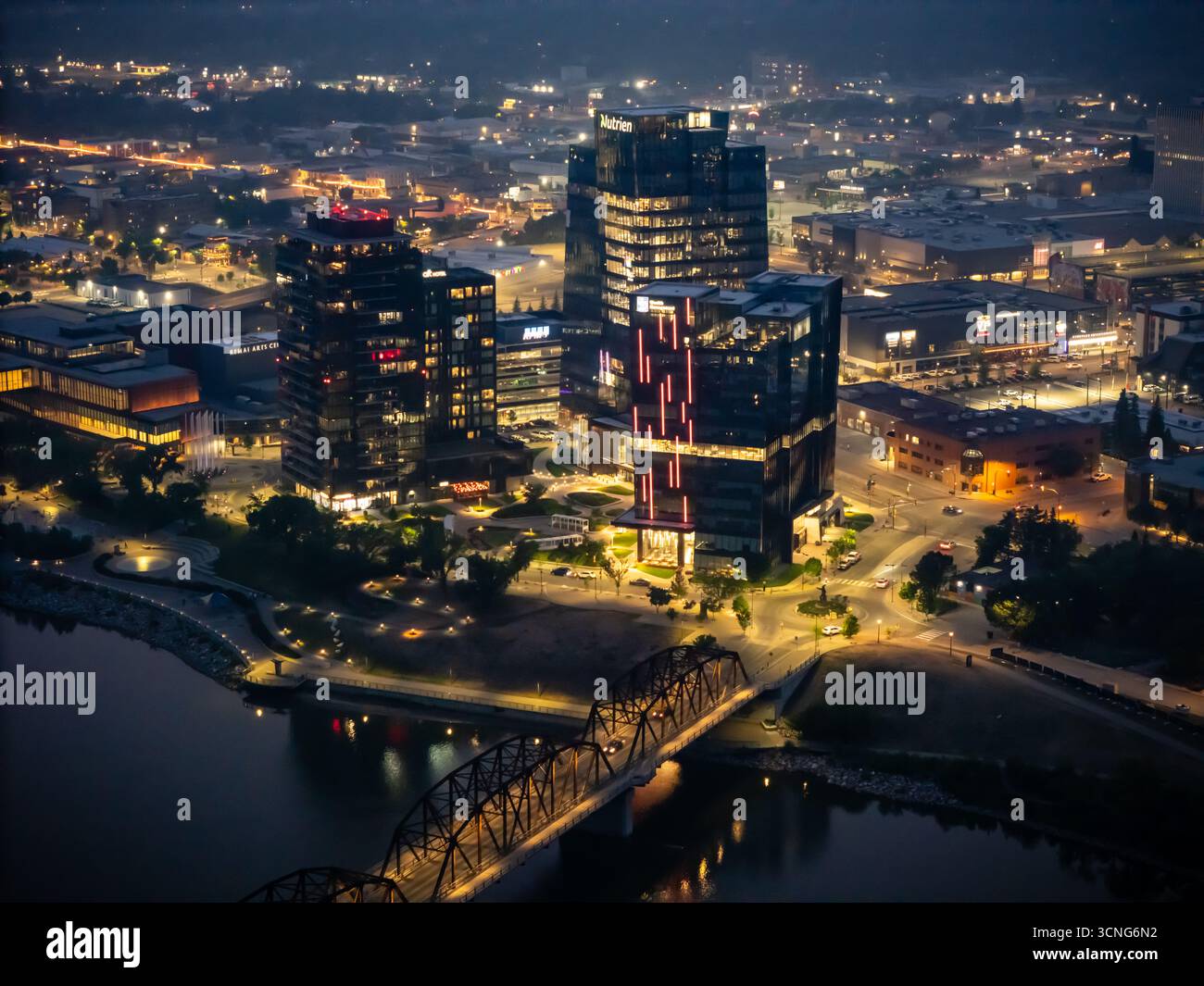 Aerial night view of downtown Saskatoon, Saskatchewan, featuring the city skyline, bridges, and illuminated streets. Stock Photo