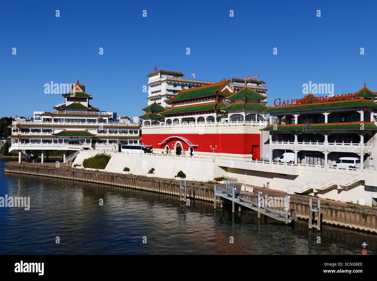 The view of the chinese-inspired architecture of the Huatian Chinagora complex with curved roof corners and traditional glazed roof tiles. Stock Photo